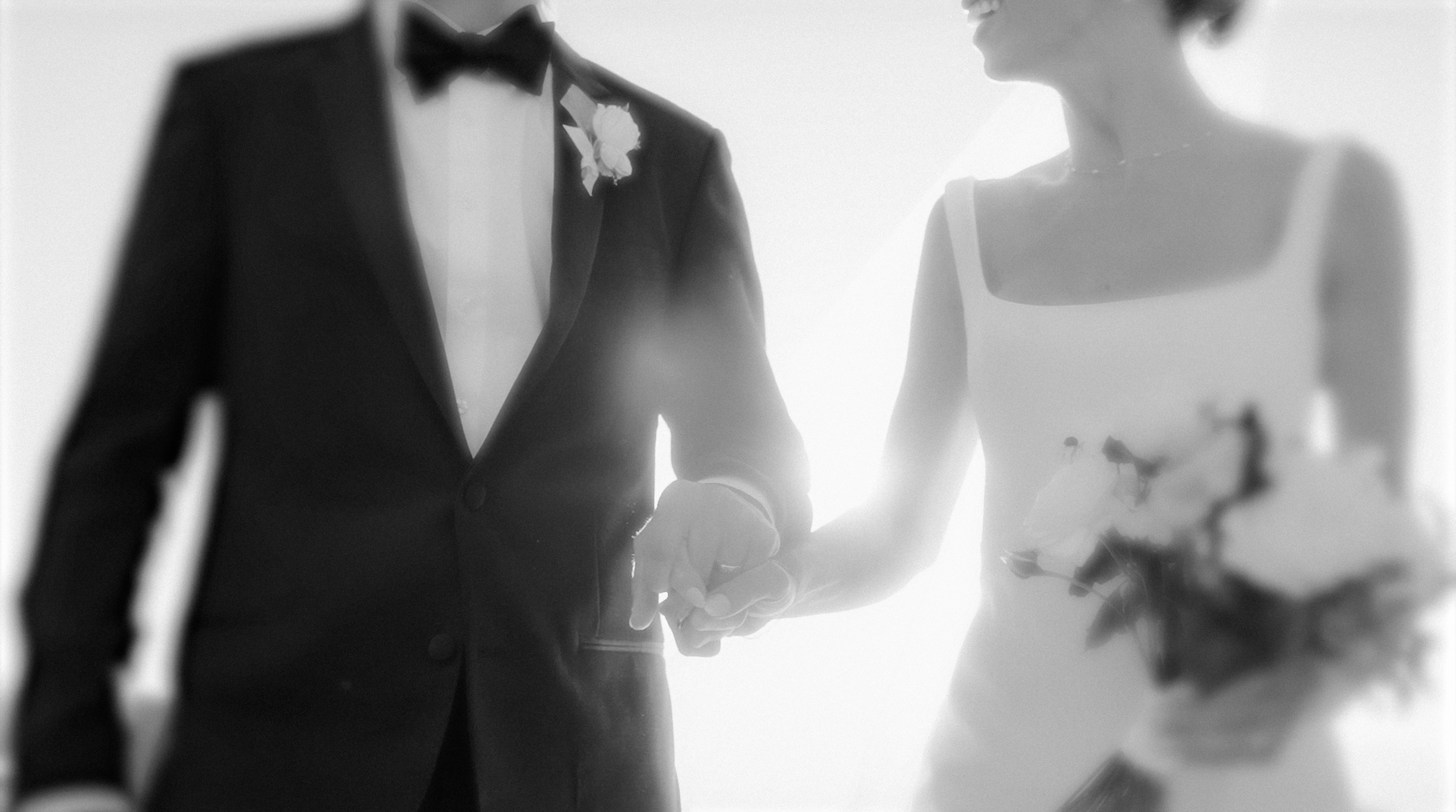 Bride and groom holding hands.
