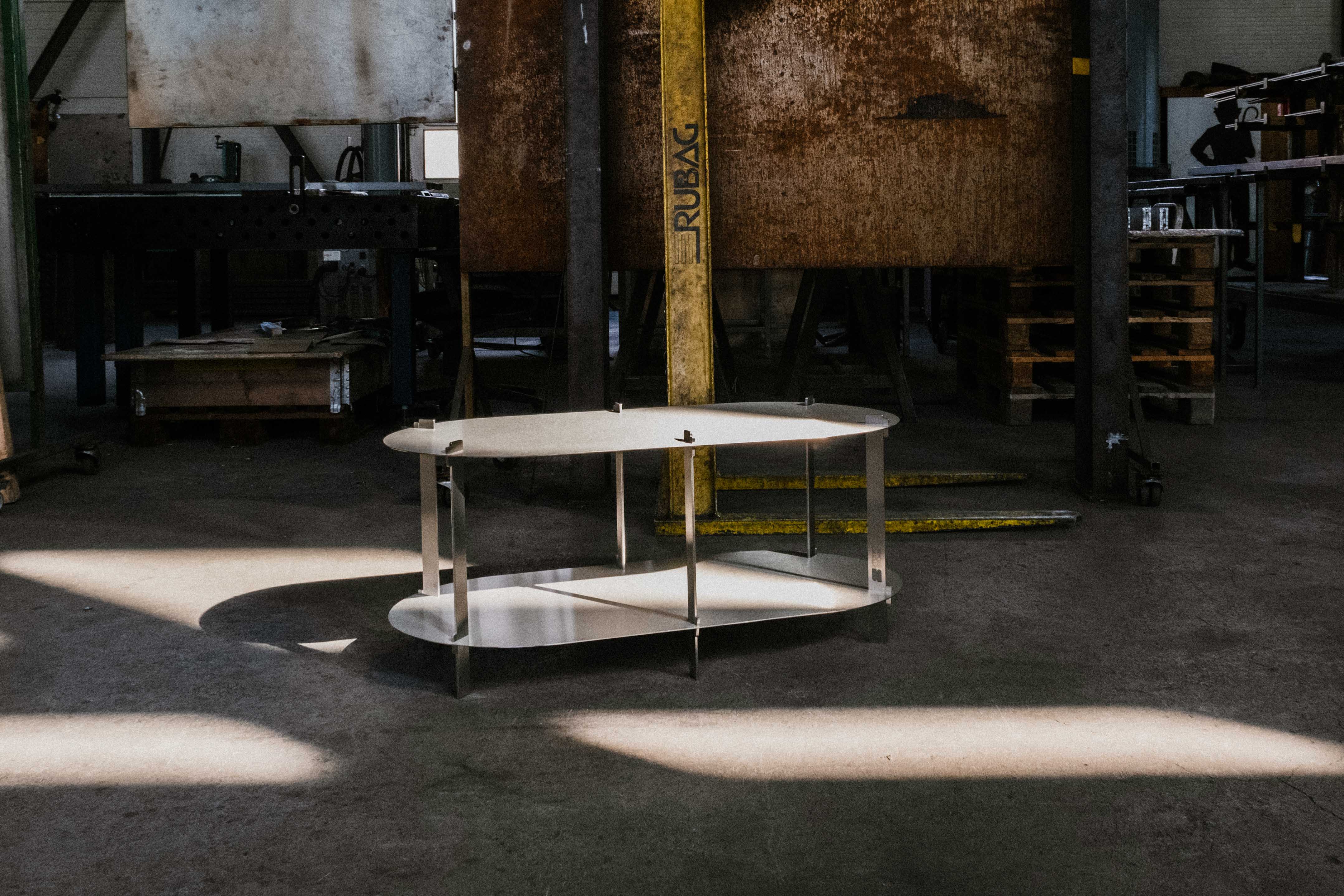 Large Steel Coffee Table in a workshop, sun shining on the scene