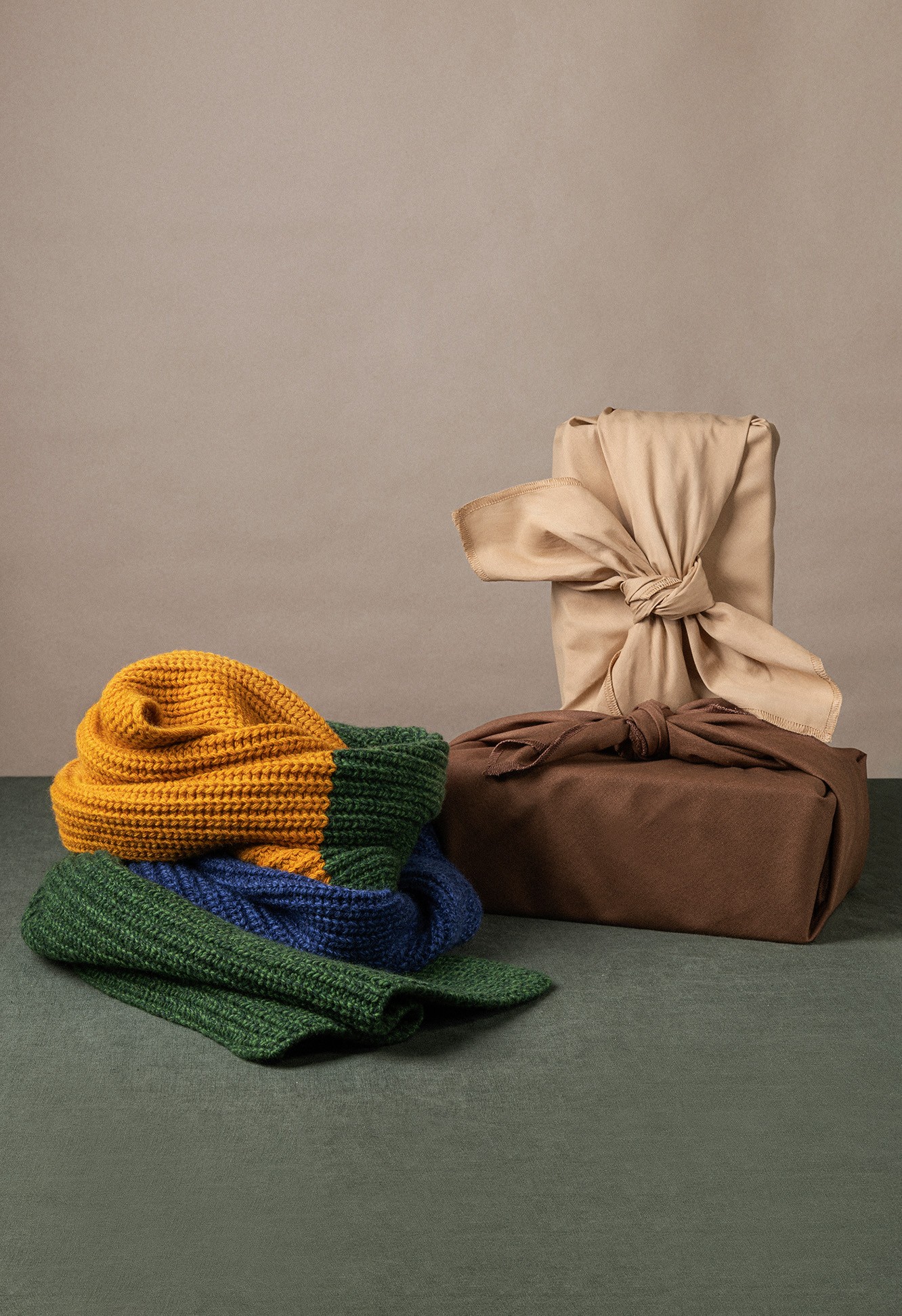 a penguin sitting on the ground next to a tree