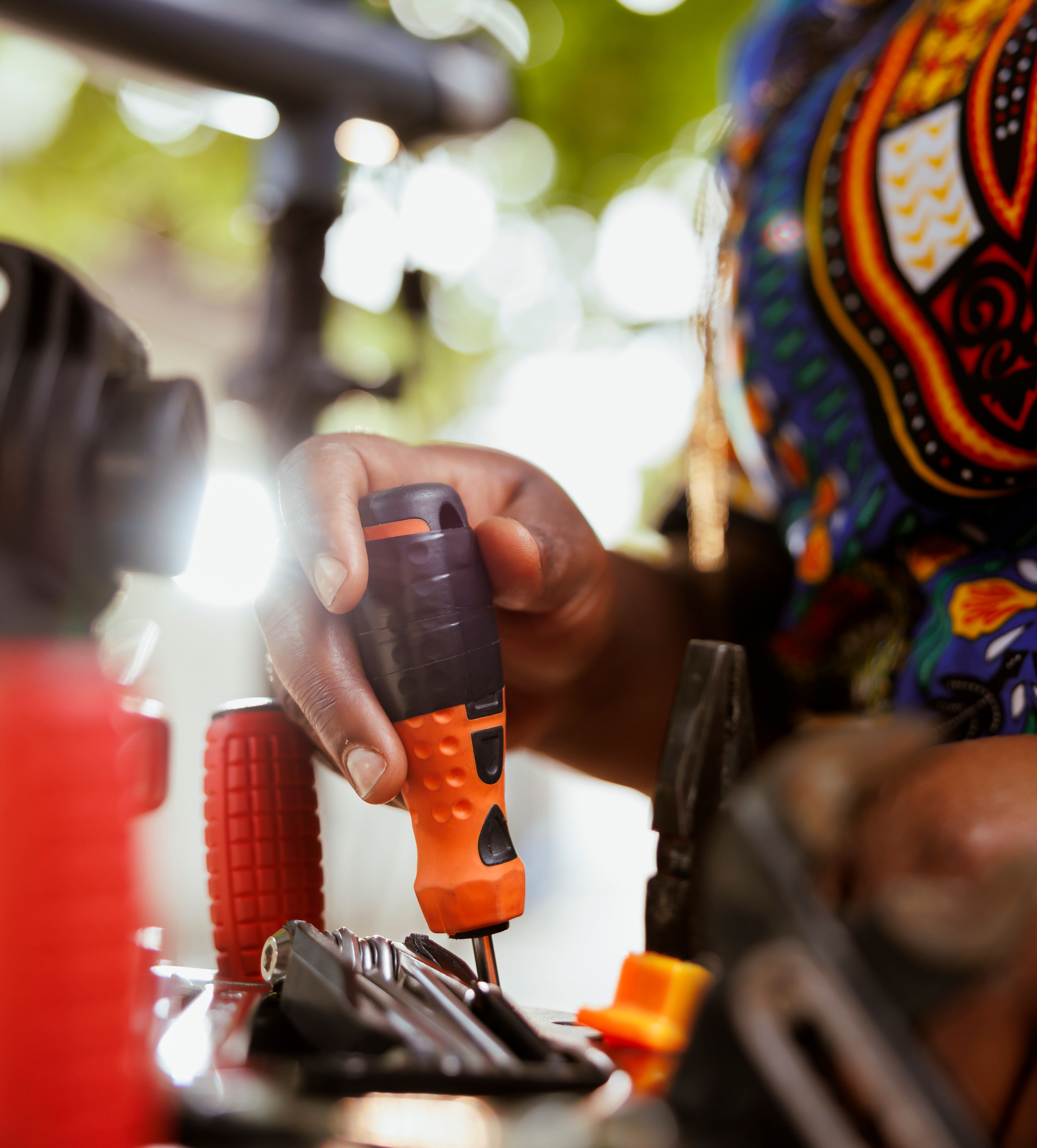 An electrician using tools to diagnose an electrical issue.