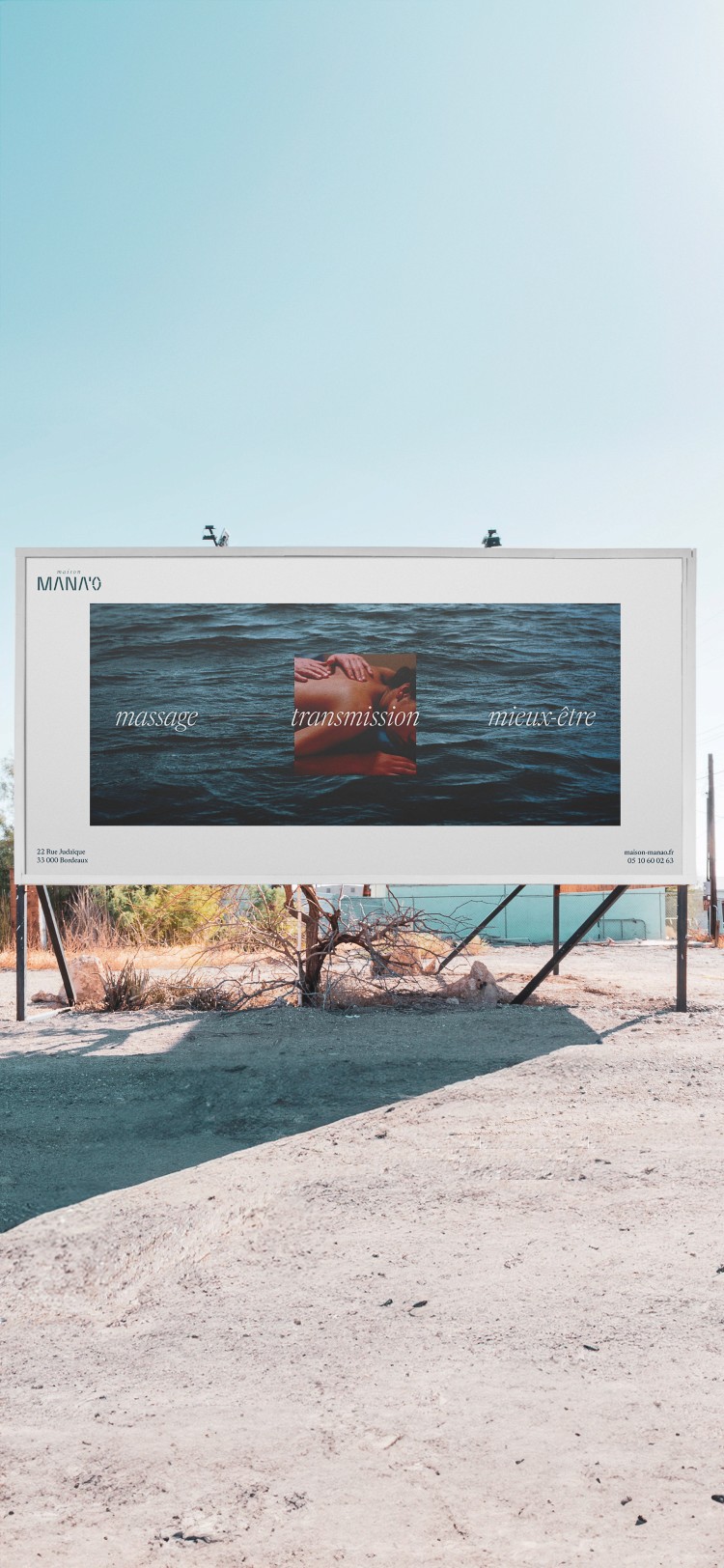 Large outdoor billboard branding for Maison MANAO showcasing ocean photography and wellness messaging.