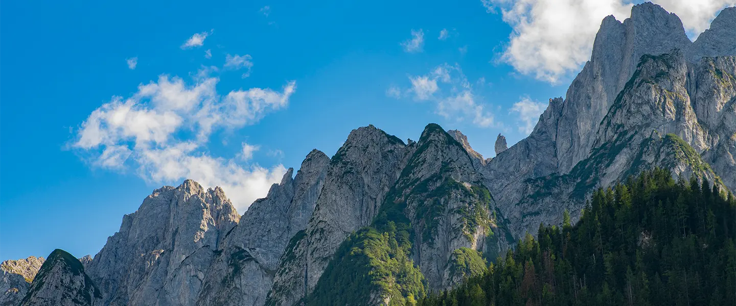 Mountain peaks under a sunny blue sky.
