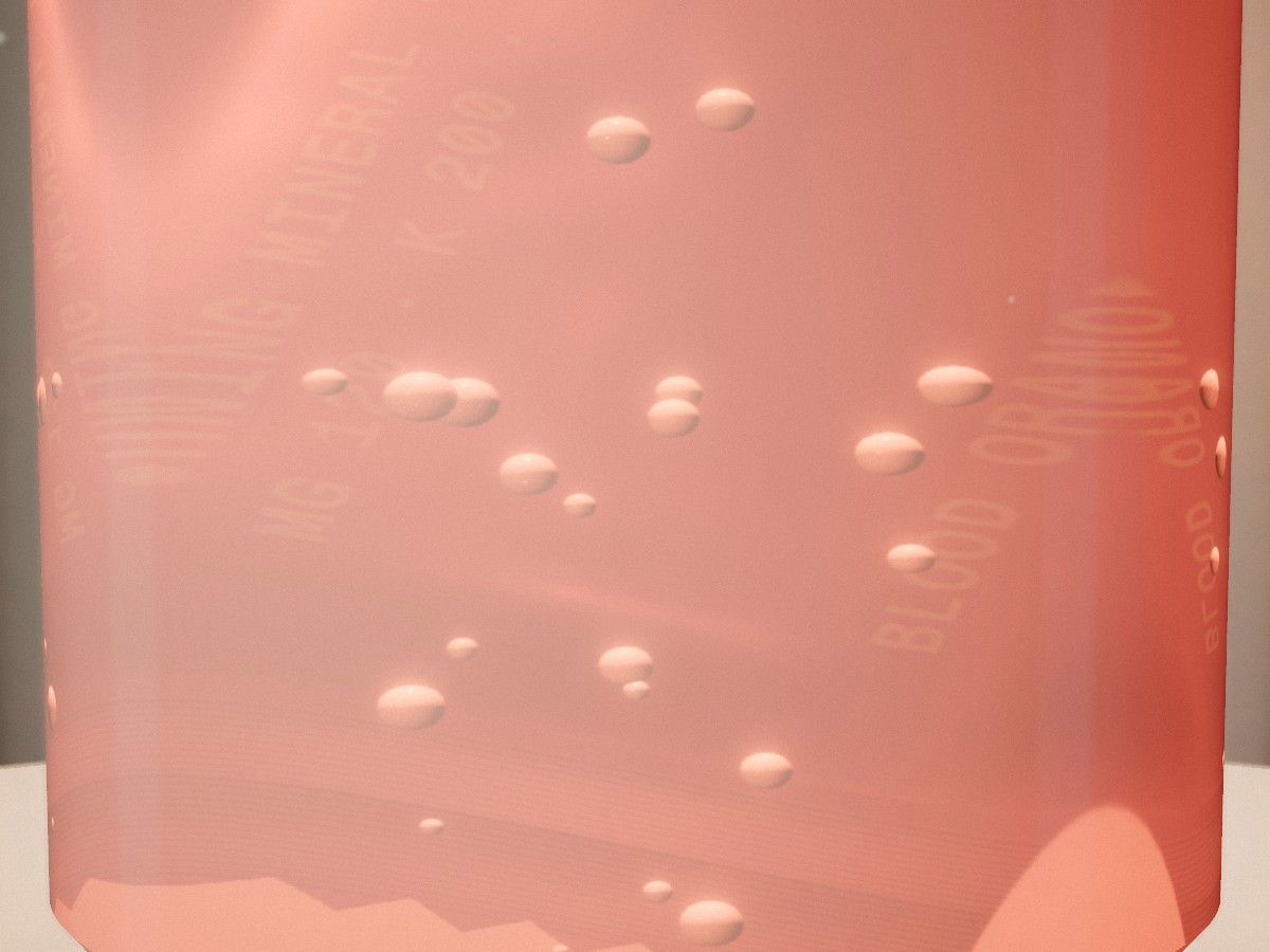 Bubbles rising through apricot mineral water, close up