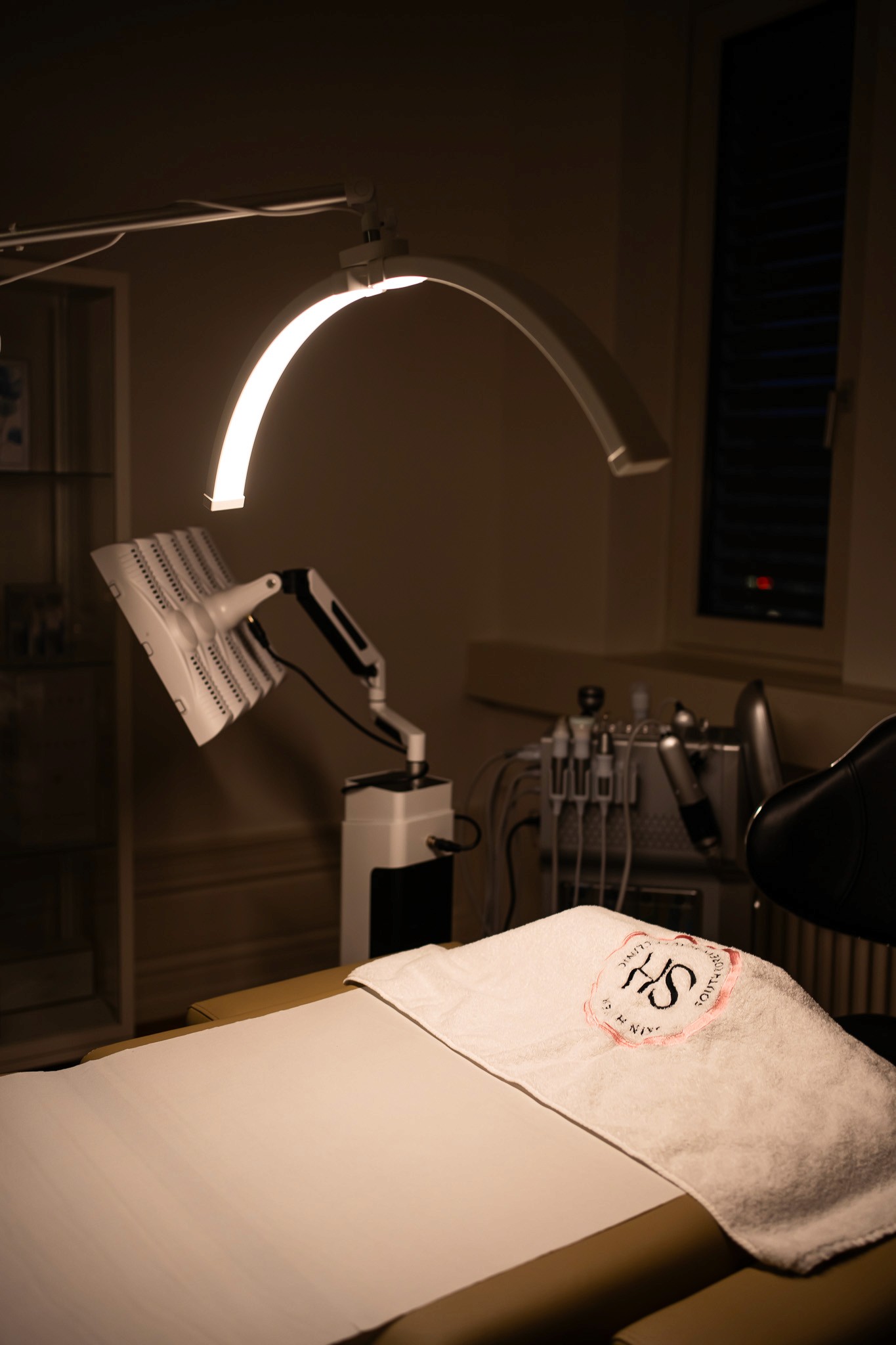 Smiling woman holding documents and using her phone in an office