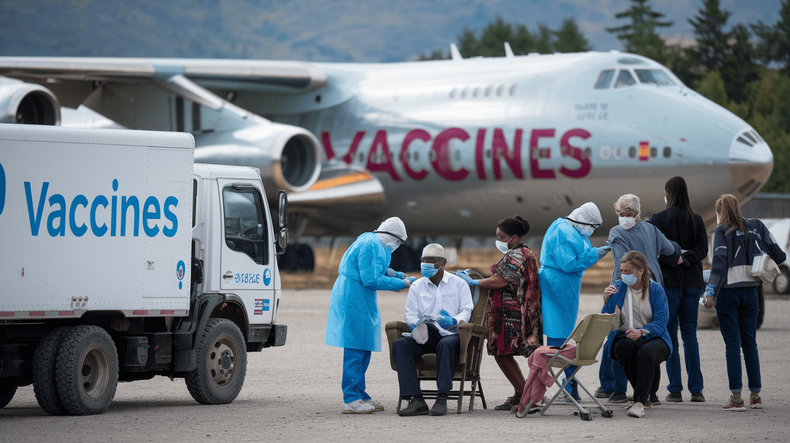 Vaccine distribution setup with a refrigerated truck, medical staff, and an aircraft, emphasizing global vaccine accessibility.