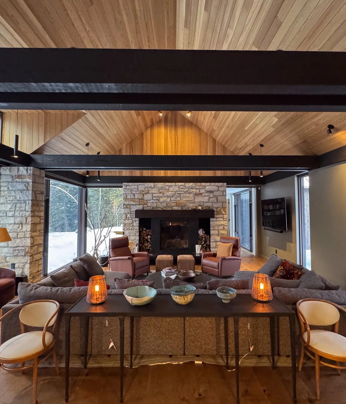 interior view of a luxury haliburton cottage open concept living room with timber beams.