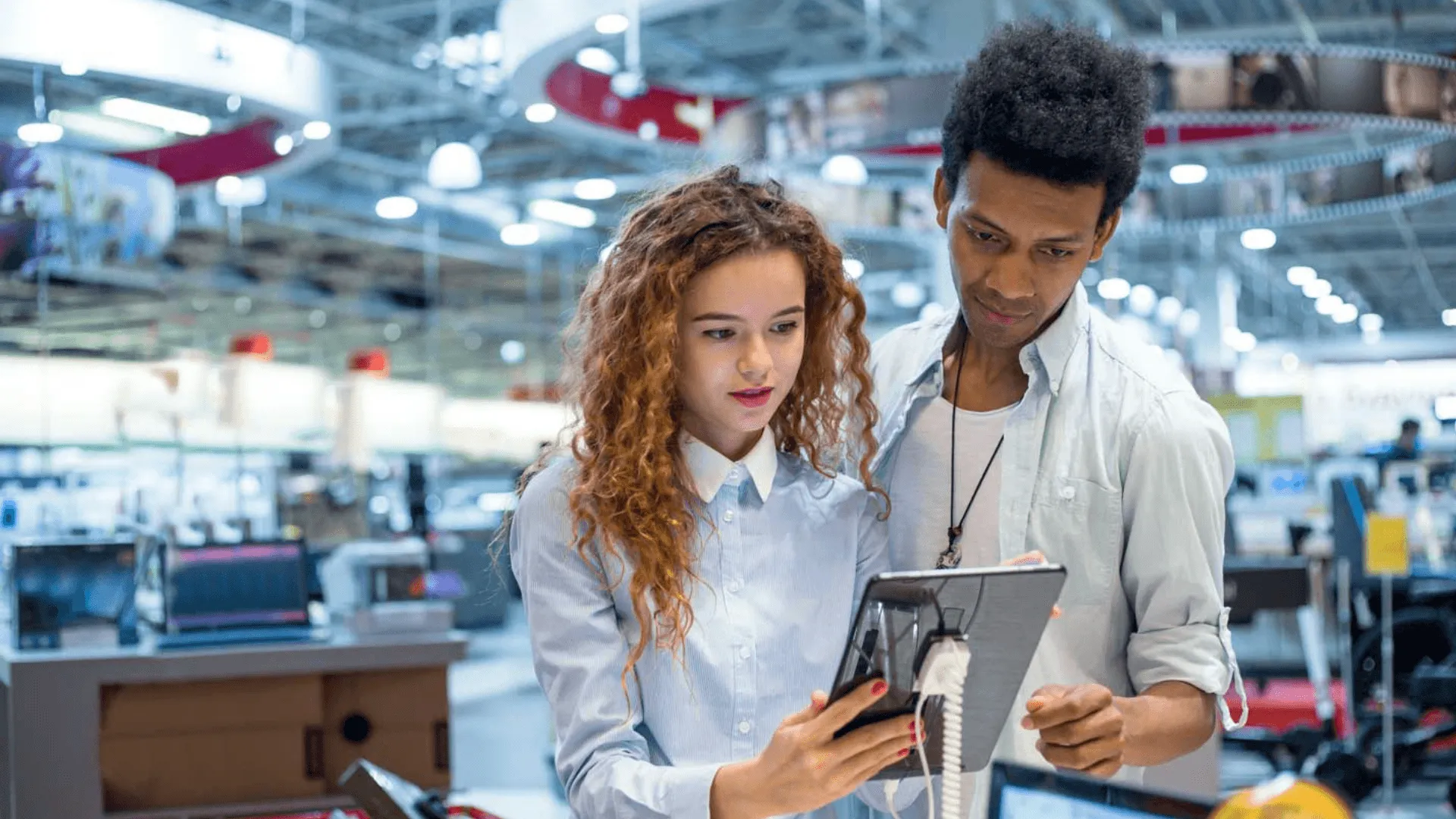 Two people looking at a tablet in a warehouse
