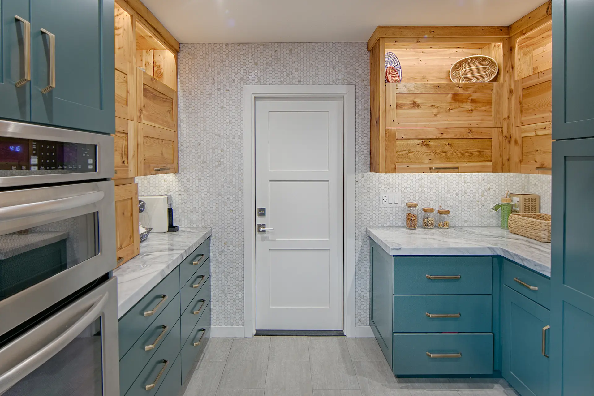 Compact kitchen with teal cabinets, wood accents, and modern appliances in Huntington Beach Kitchen & Bath Remodel.