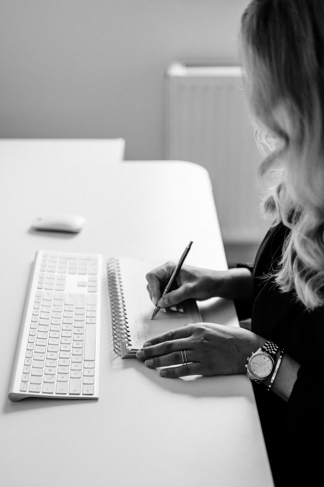 woman sitting around table holding tablet