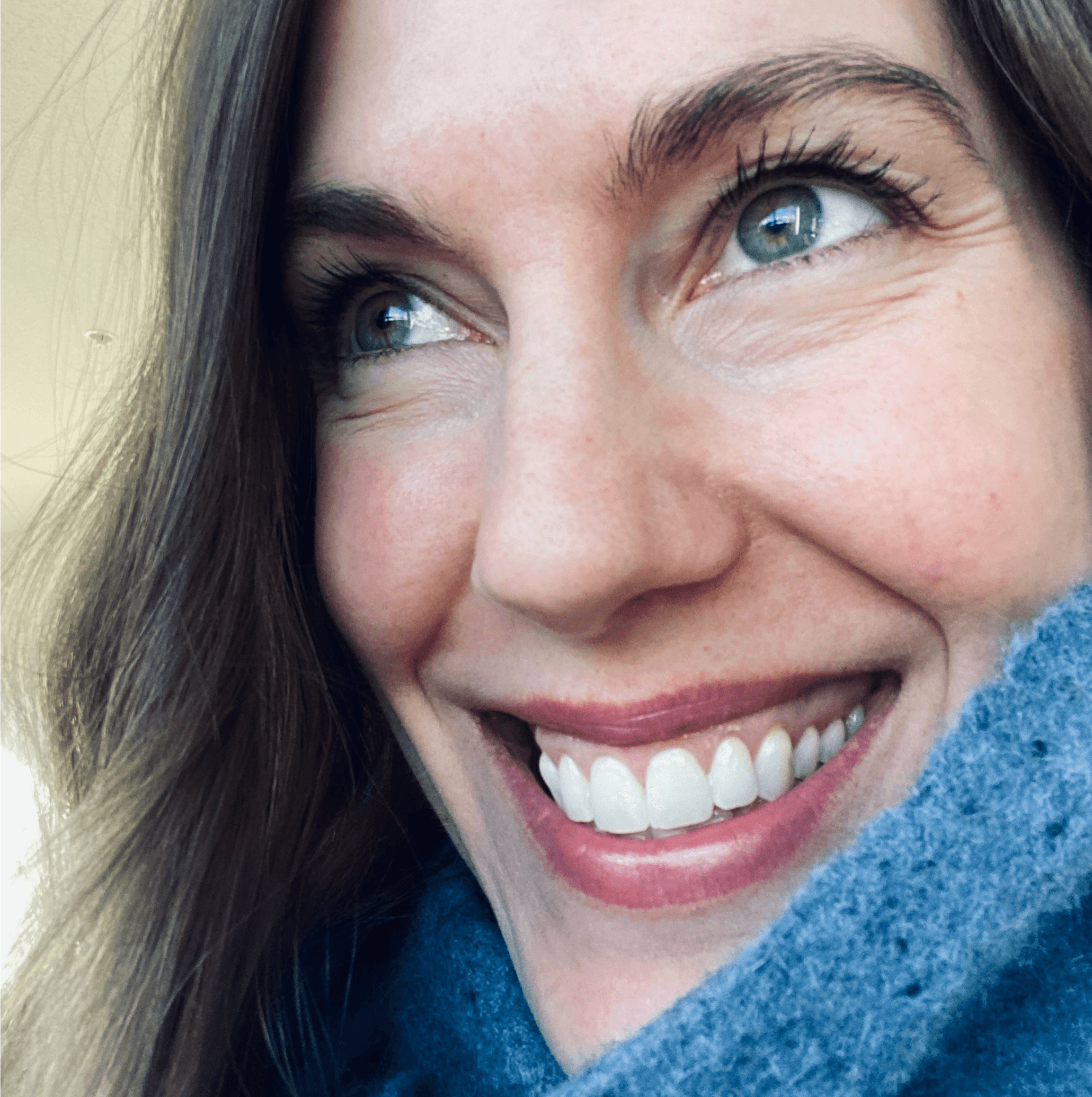 Profile photo of Rachel Pursell smiling, with fair skin, round glasses, and wavy brown hair