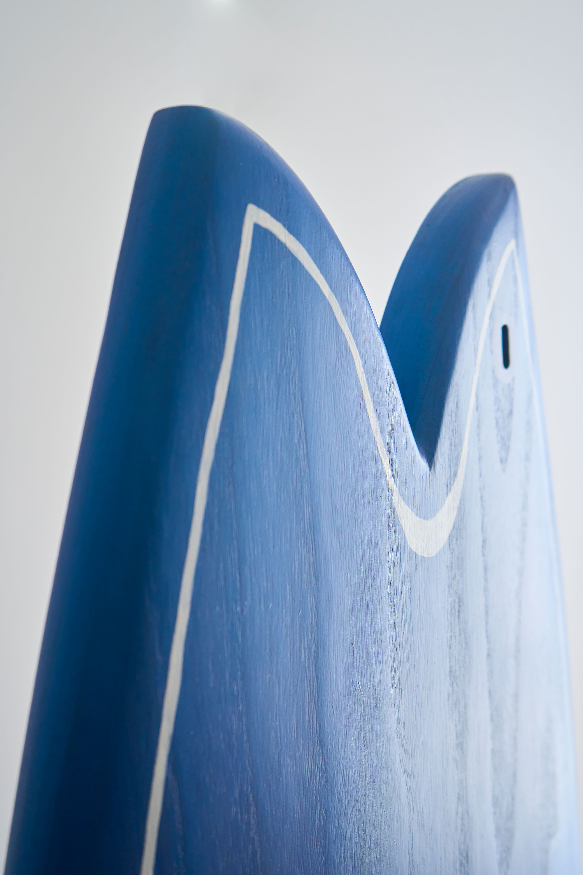 Blue wooden surfboard fish tail shape