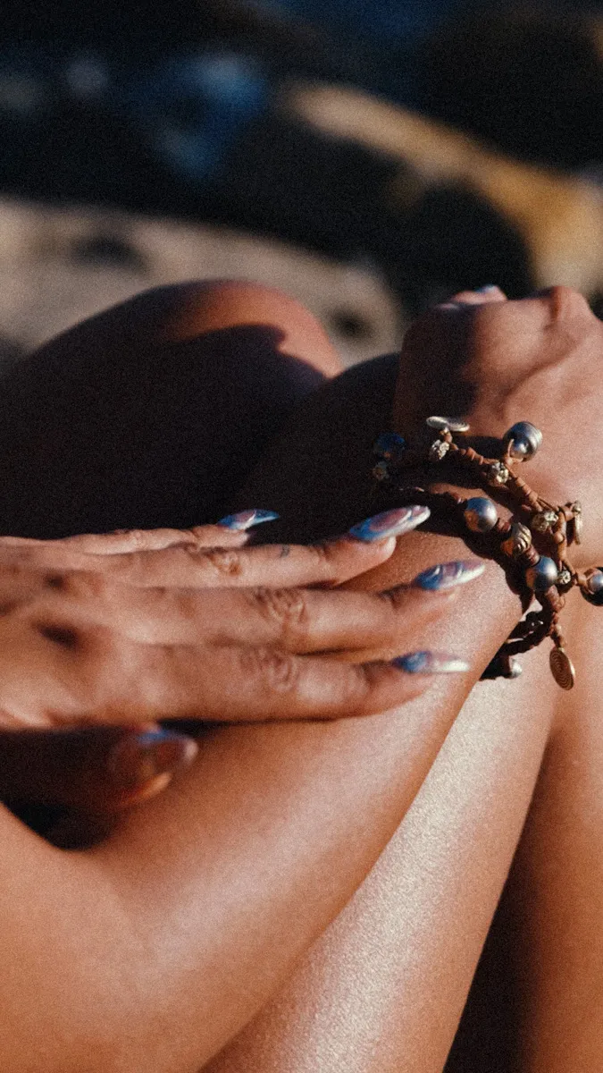 Close-up of manicured hands cradling a handcrafted gold bracelet adorned with Tahitian pearls and raw diamond accents — nature's finest treasures woven into something rare and meaningful. Jewelry with a soul, crafted by hand — Manos de Oro Saint Barth.