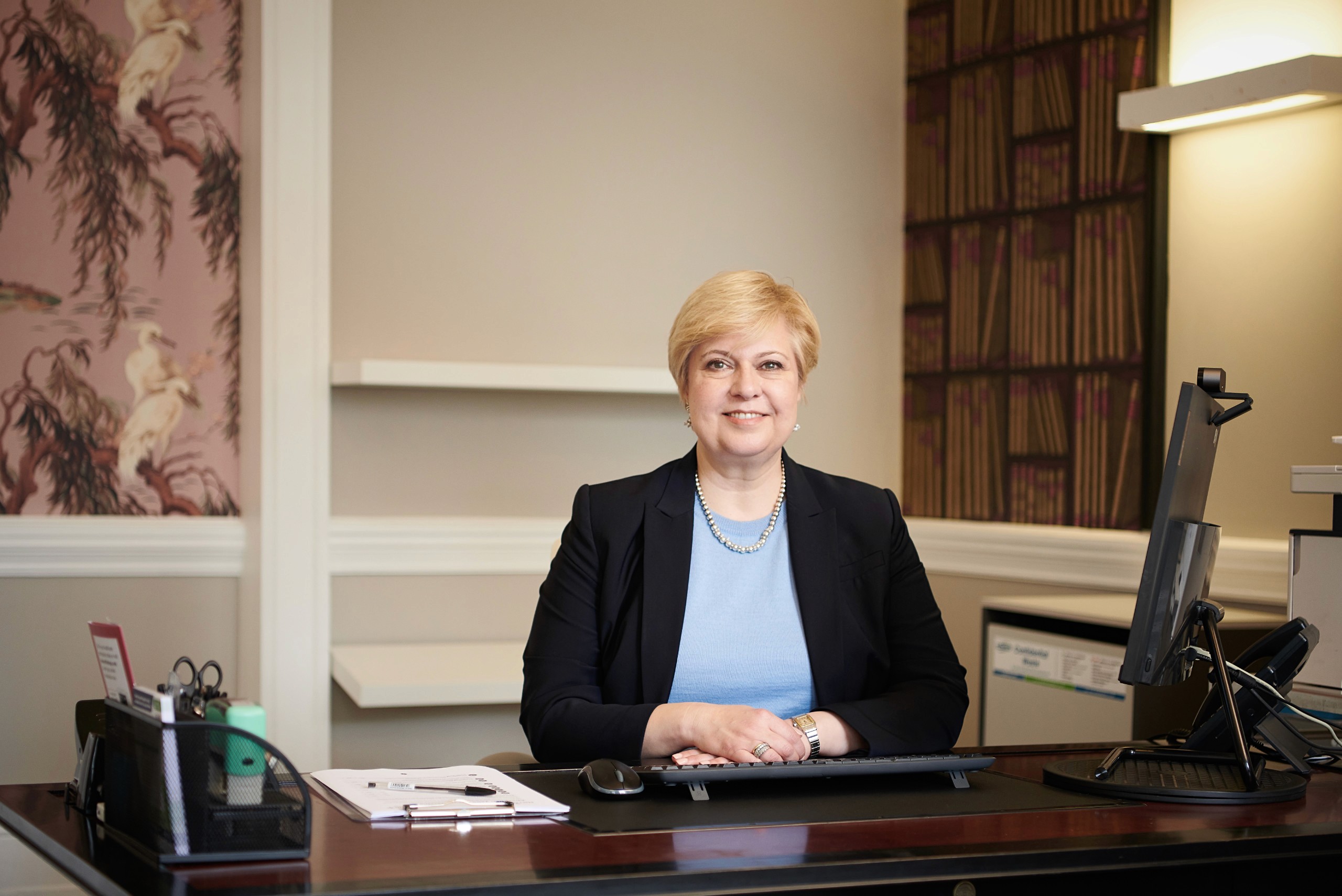 Photo of consultant doctor Eirini Lentari in her clinic office with computer to the left hand side