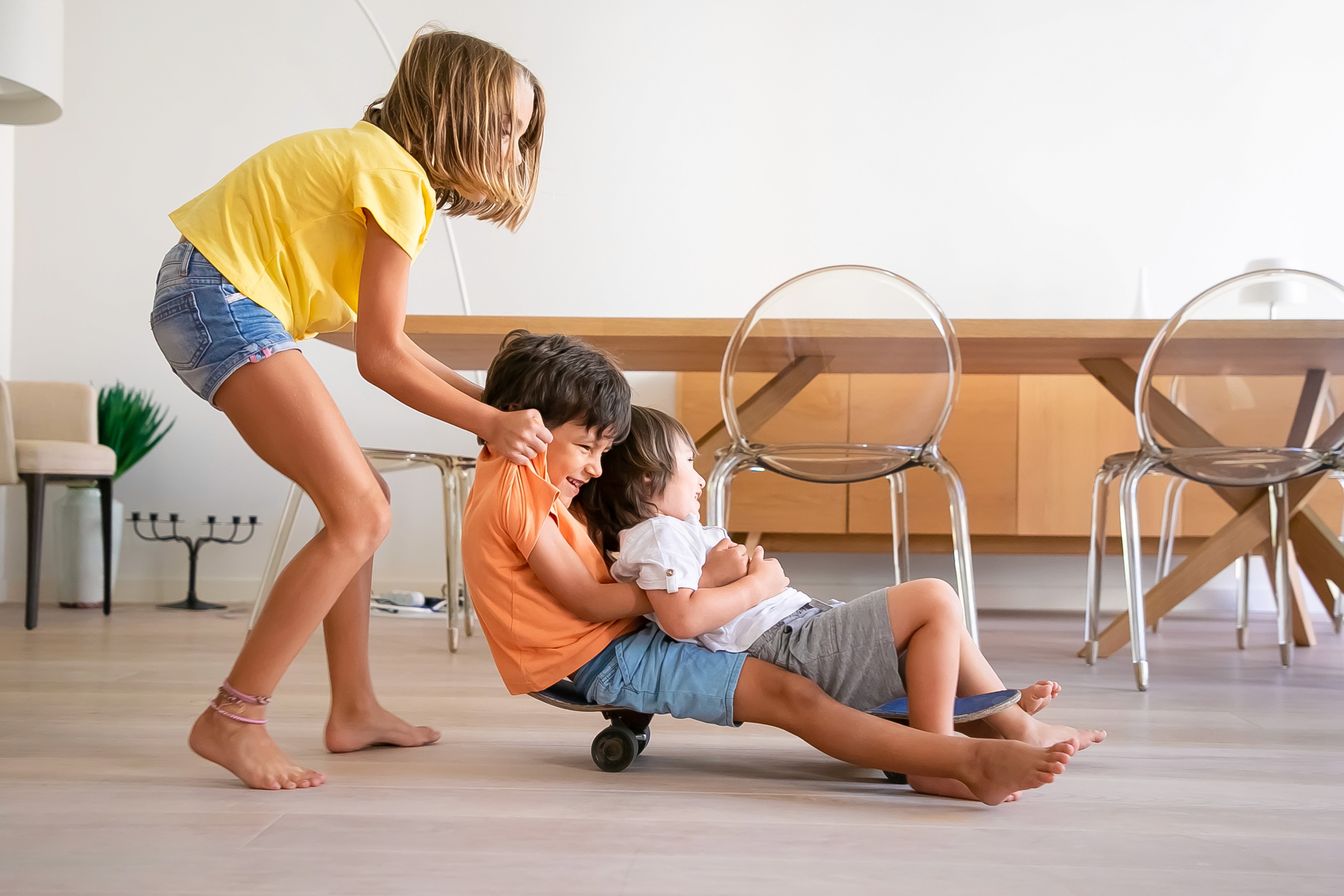 Children play safely indoors on LUXO’s light wood-look hybrid flooring, showcasing a slip-resistant, durable, and family-friendly surface designed for active Australian homes.