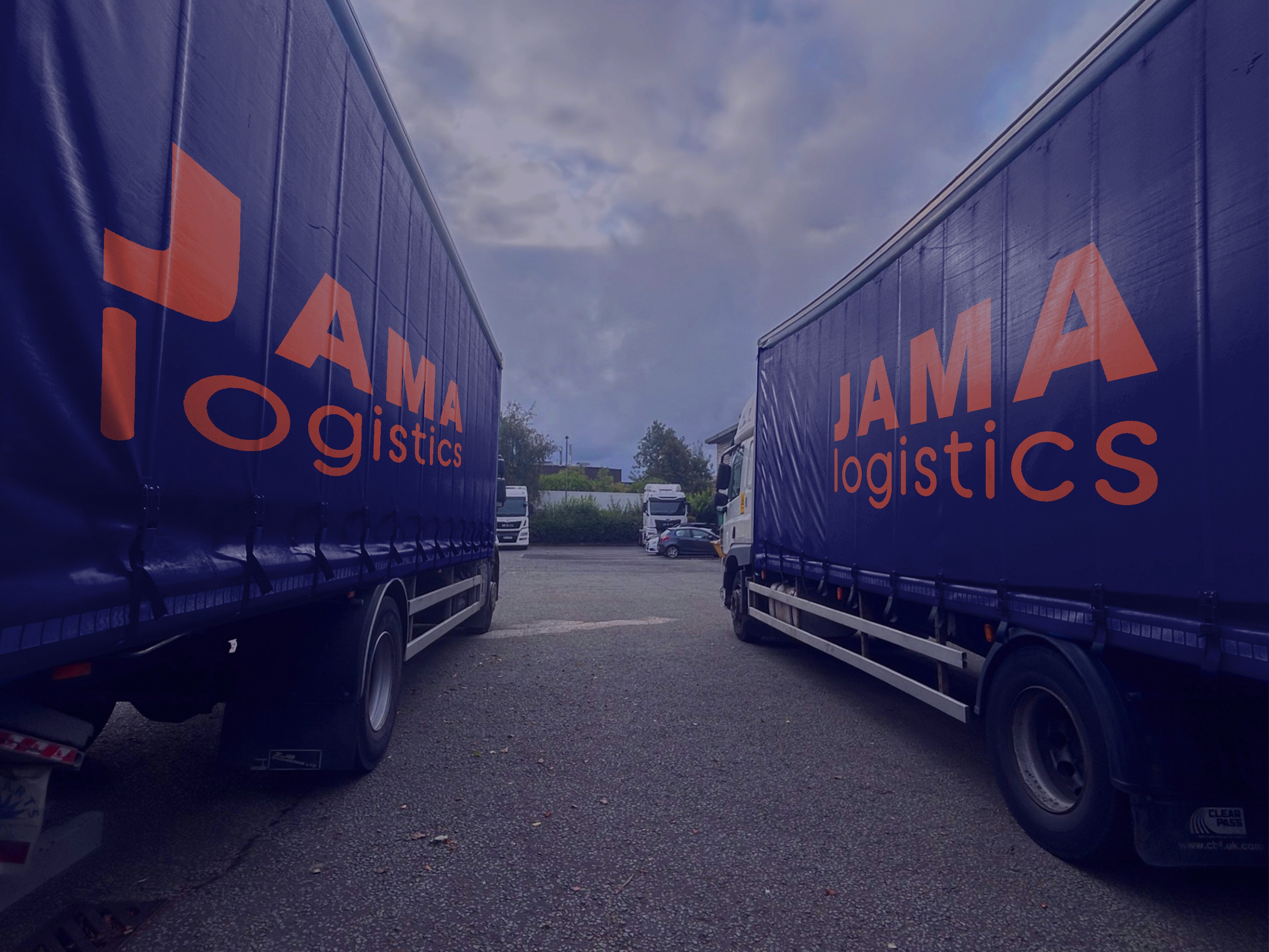 image of two trucks with jama logistics livery on the side of them parked next to each other