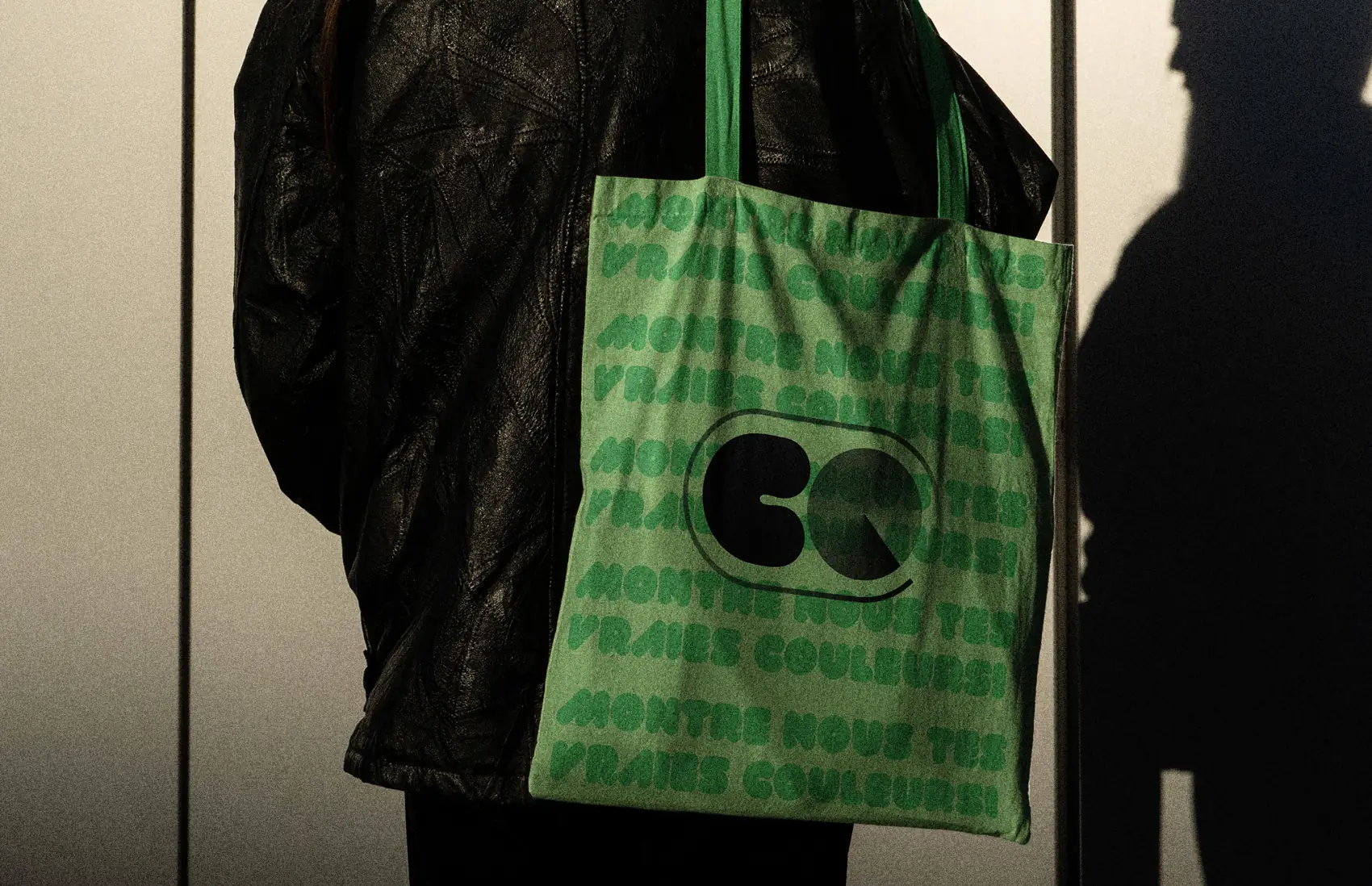 Green tote bag printed with the bold COLORS geometric logo.