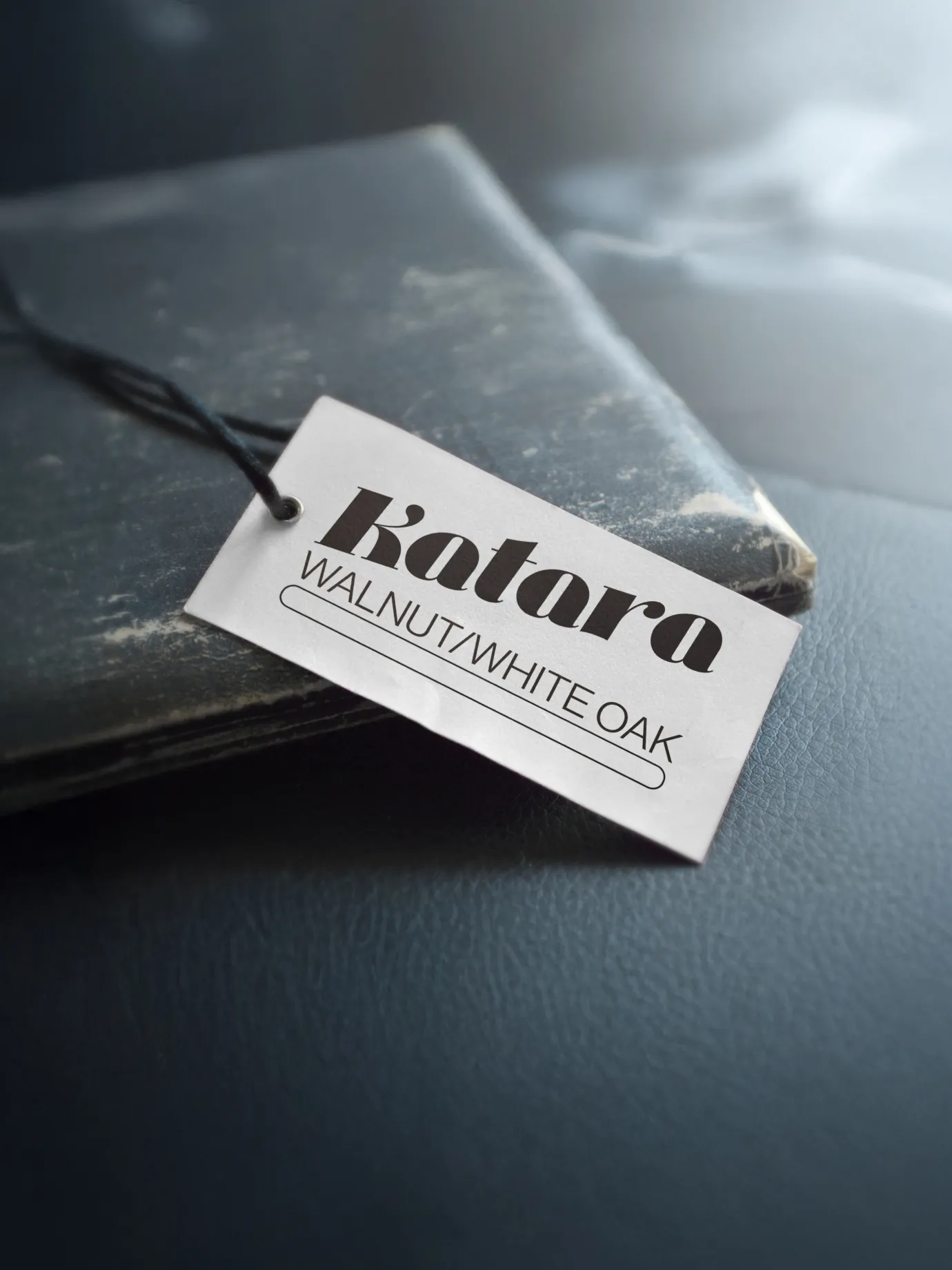 D’Andre Furniture — Branded tag hanging from Katara table — Product collateral