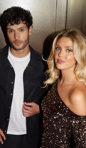 A young man and woman in a fashionable clothes, looking at the camera