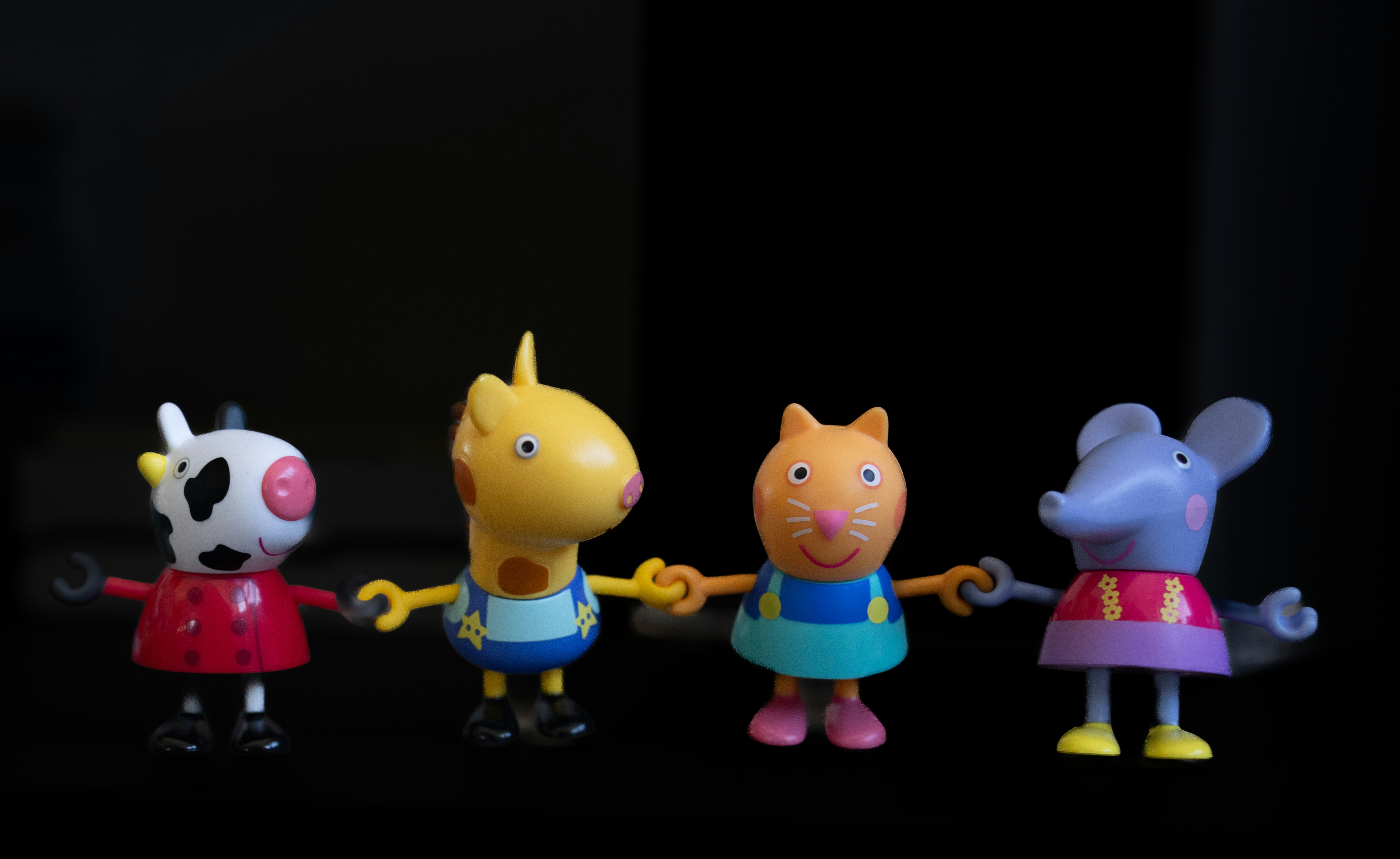 Colorful toy figures standing together against a dark background