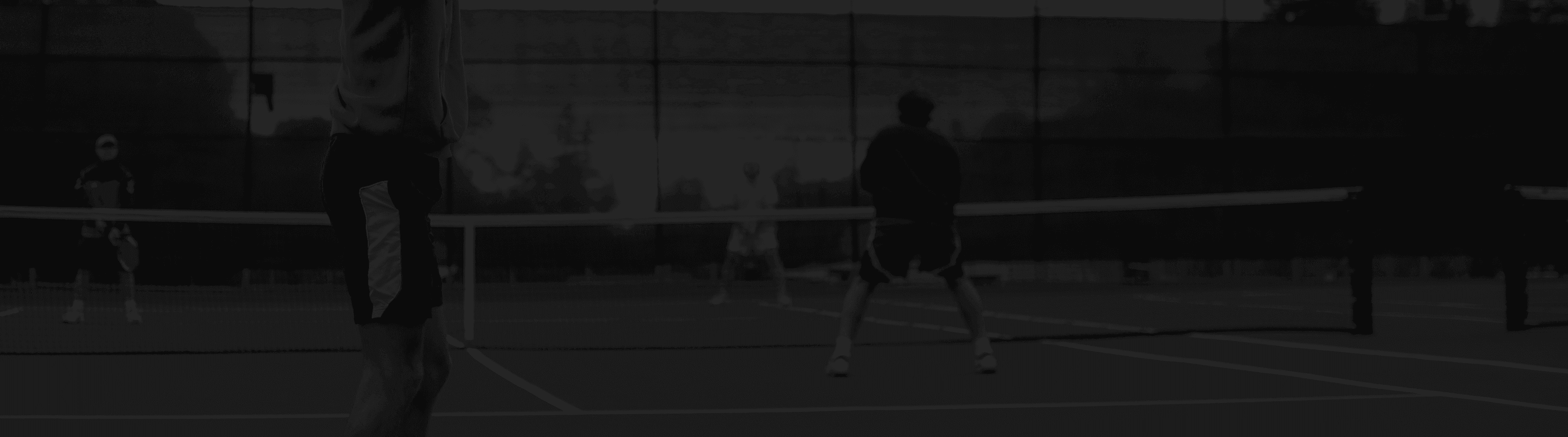 four men playing double tennis during daytime