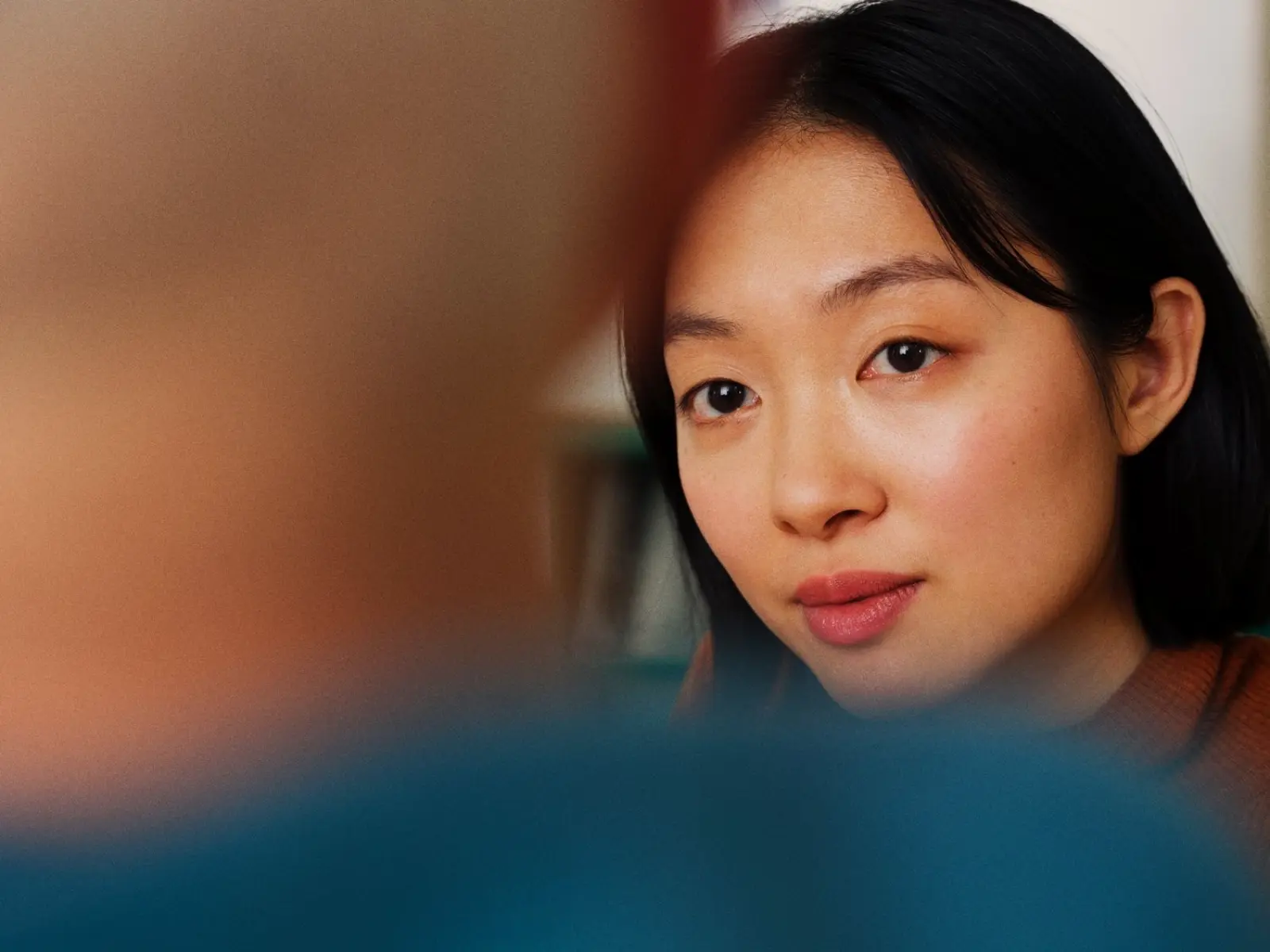 The image features two hands reaching towards each other against a plain background. 