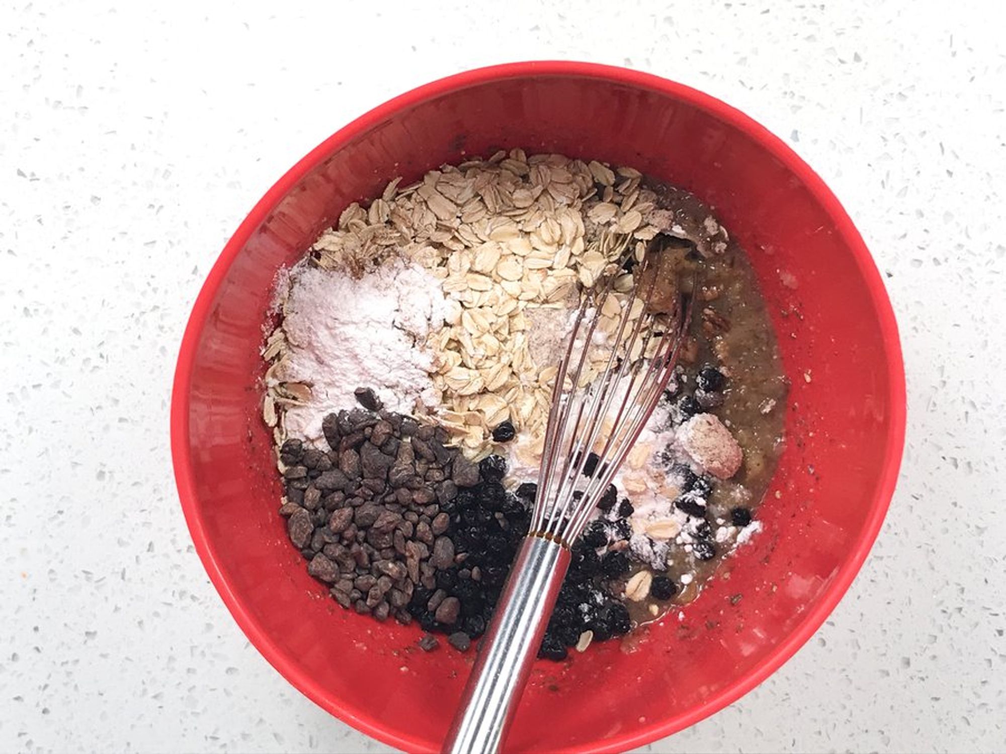 applesauce, maple syrup, coconut oil, almond butter, and flax ready to be mixed in a bowl