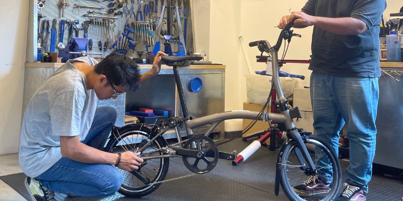 Staff of The Bike Artisans customising a bike for a customer