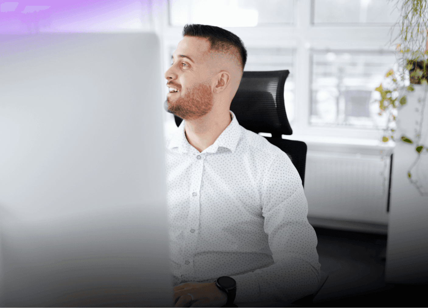 Portrait of a smiling Nextio digital agency consultant working in a bright modern office environment.