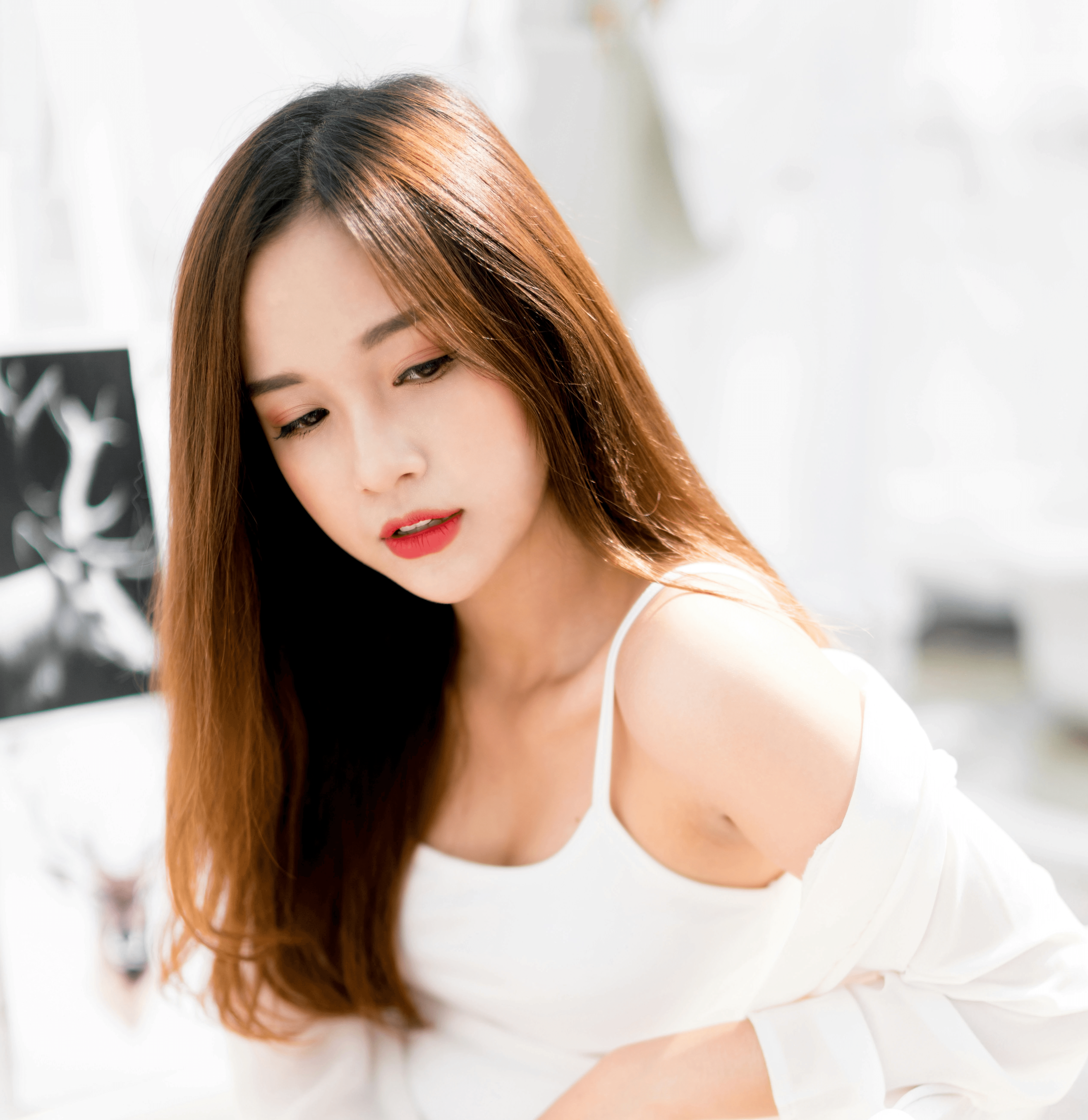 woman sitting on white metal stair railing during daytime