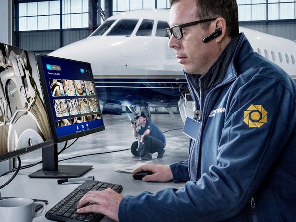 A photo of an industrial engineer wearing a RealWear headset and working on some equipment