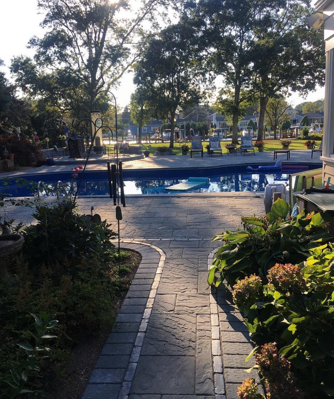 Paver pool patio with in-ground pool and landscaping by CMC Masonry on Long Island