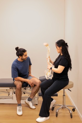 Chiropractor adjusting patient's upper back and neck.