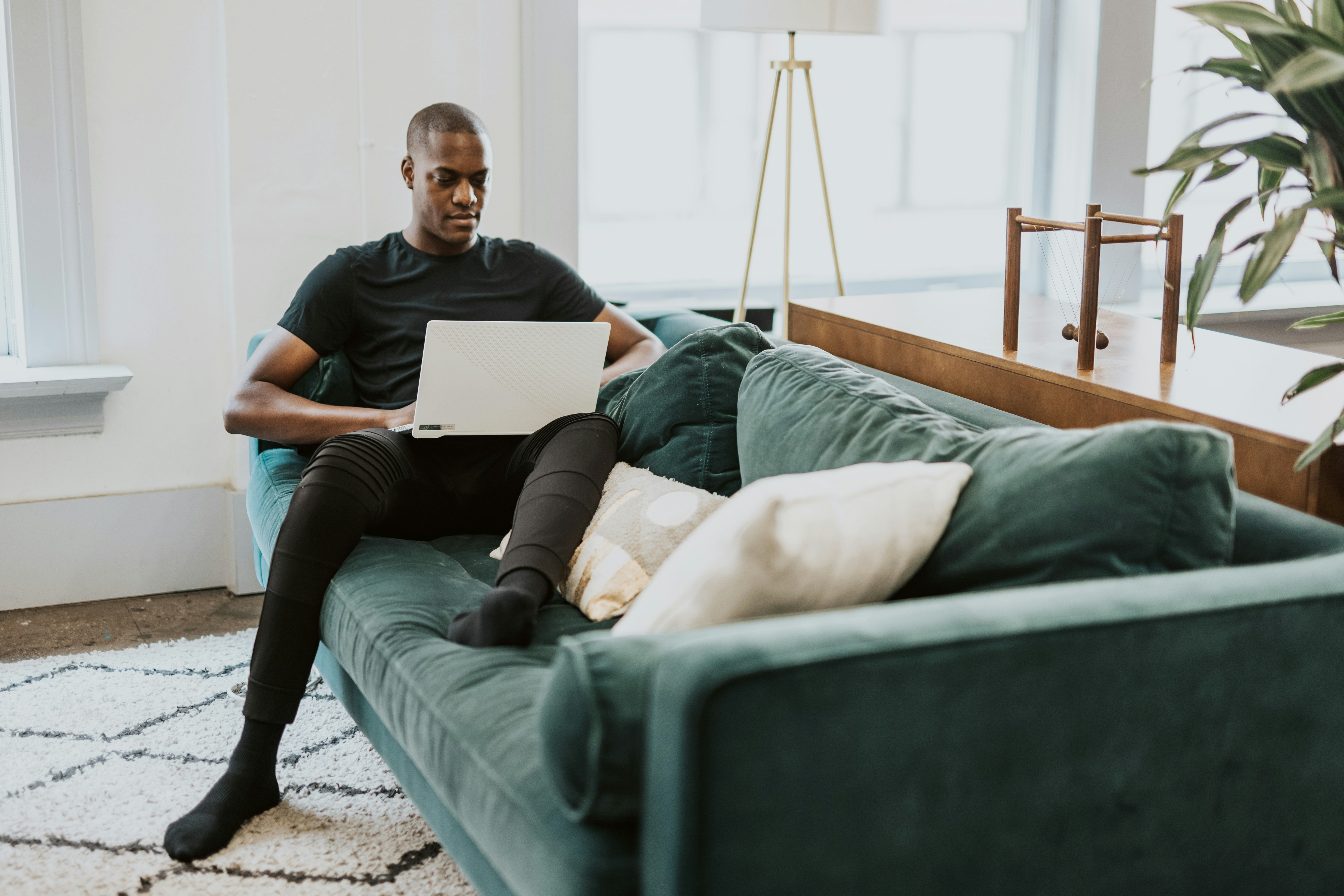 man on couch working on Spreadsheet Automation