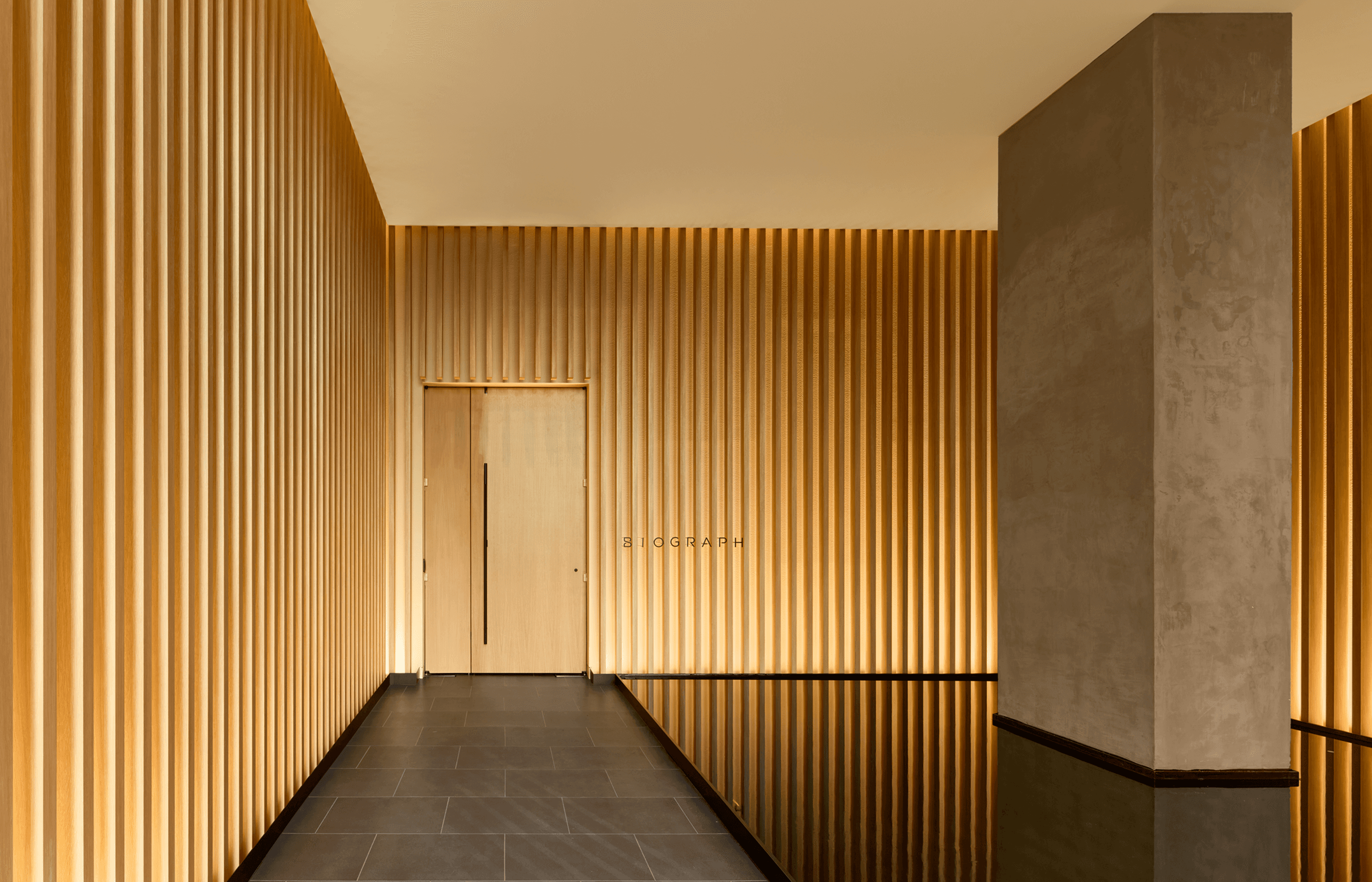 Biograph New York City main entrance with reflective pool, designed to welcome members into a serene space.