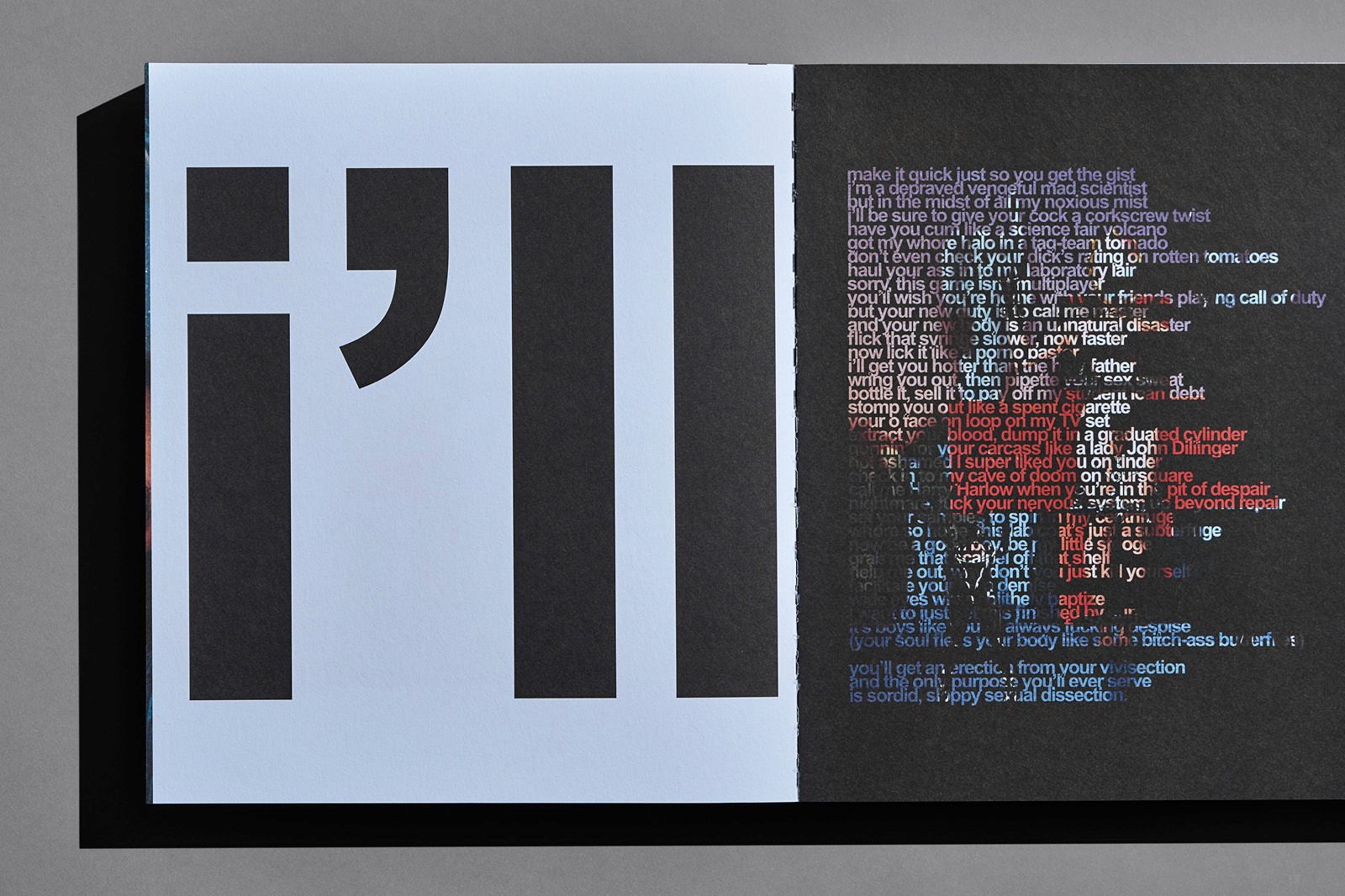 A sign features a stylized 'i' with a comma, alongside a framed artwork or poster with vibrant colors and figures.