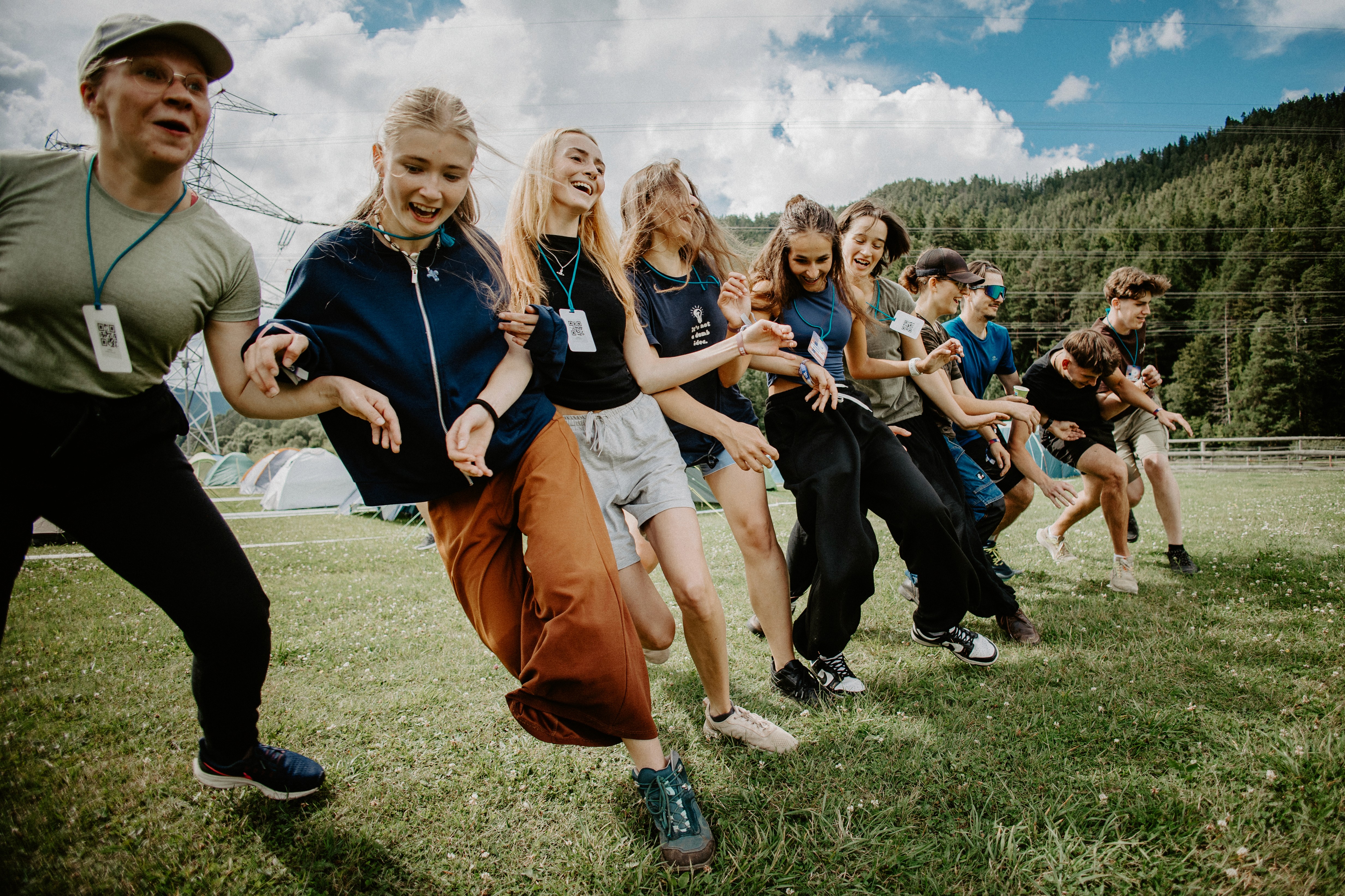 Three women holding hands at outdoor event
