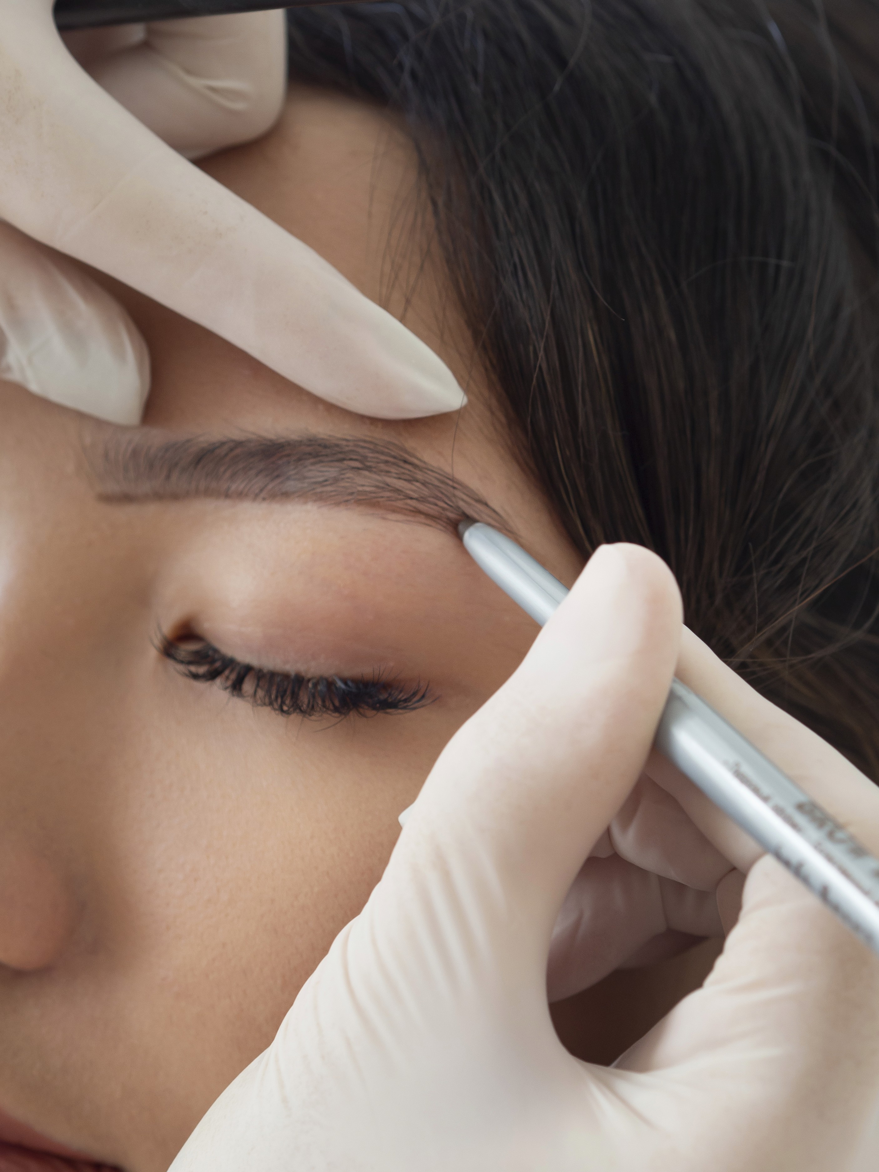 A close-up view of dark green leaves, creating a lush, textured background with subtle variations in color.
