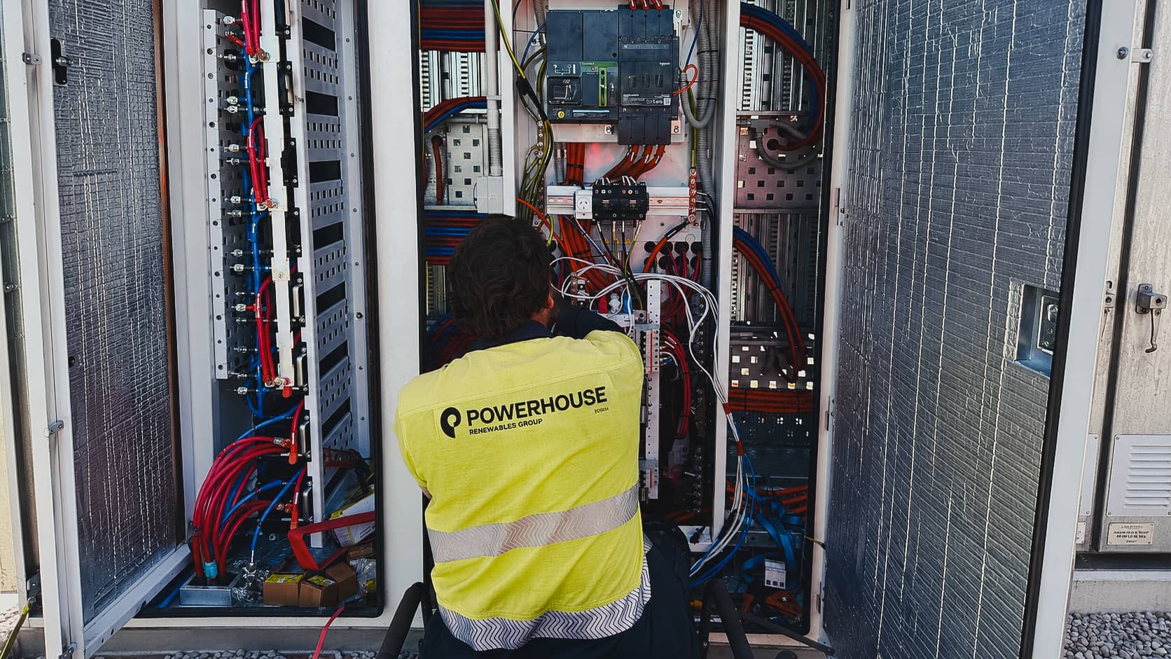 Technician servicing EV charging payment kiosk for Horizon Power EV Network in remote Western Australia.