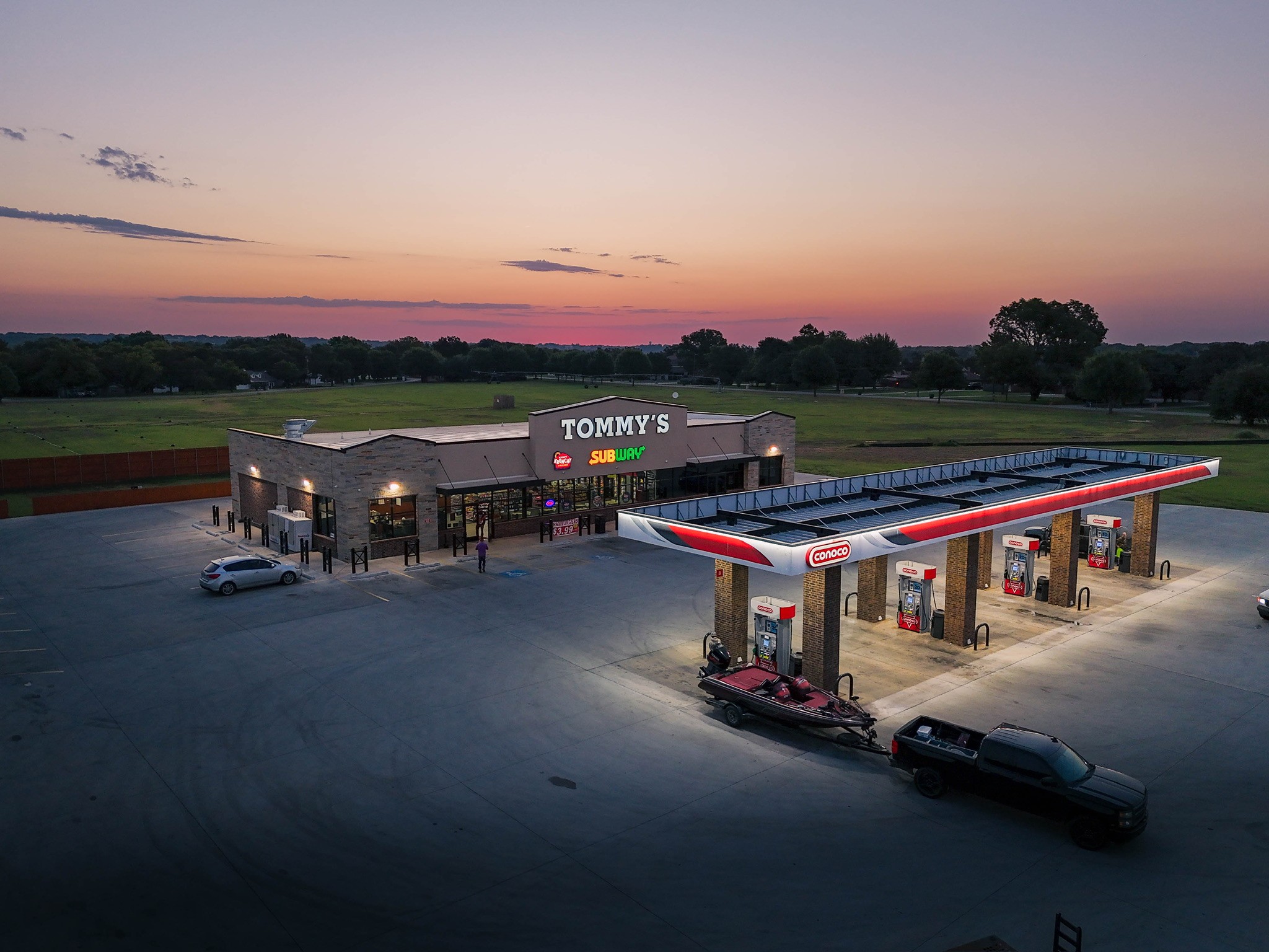 tommys subway gas station sunset truck boat large parking area