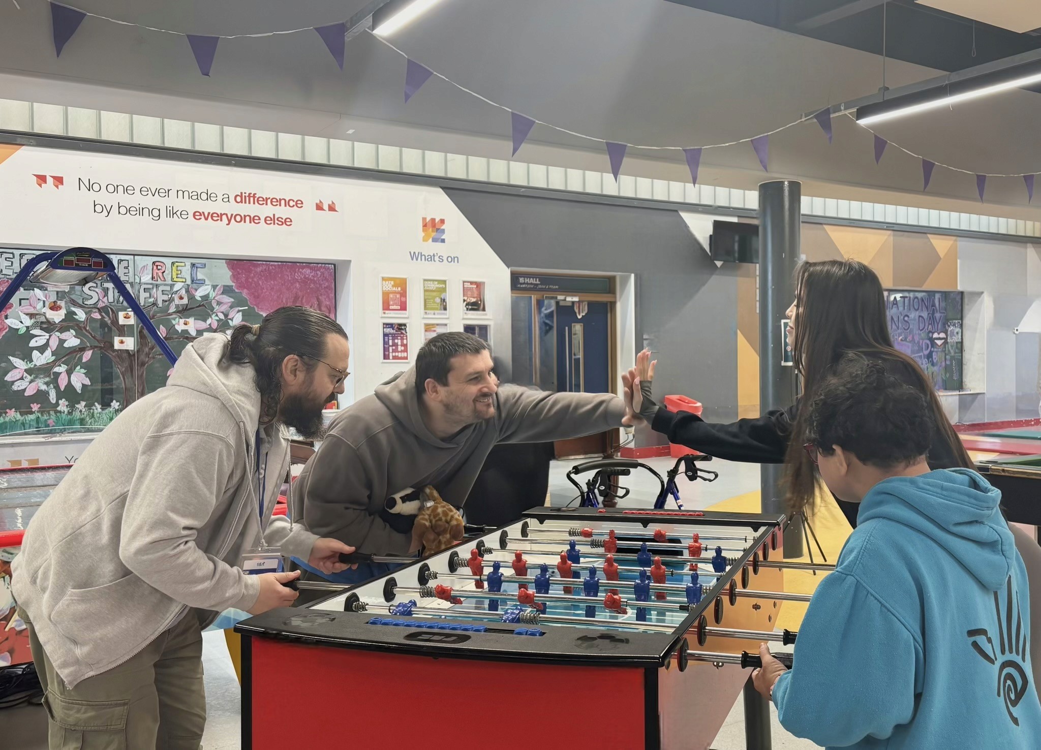 support-worker-playing-table-football-with-deaf-client.