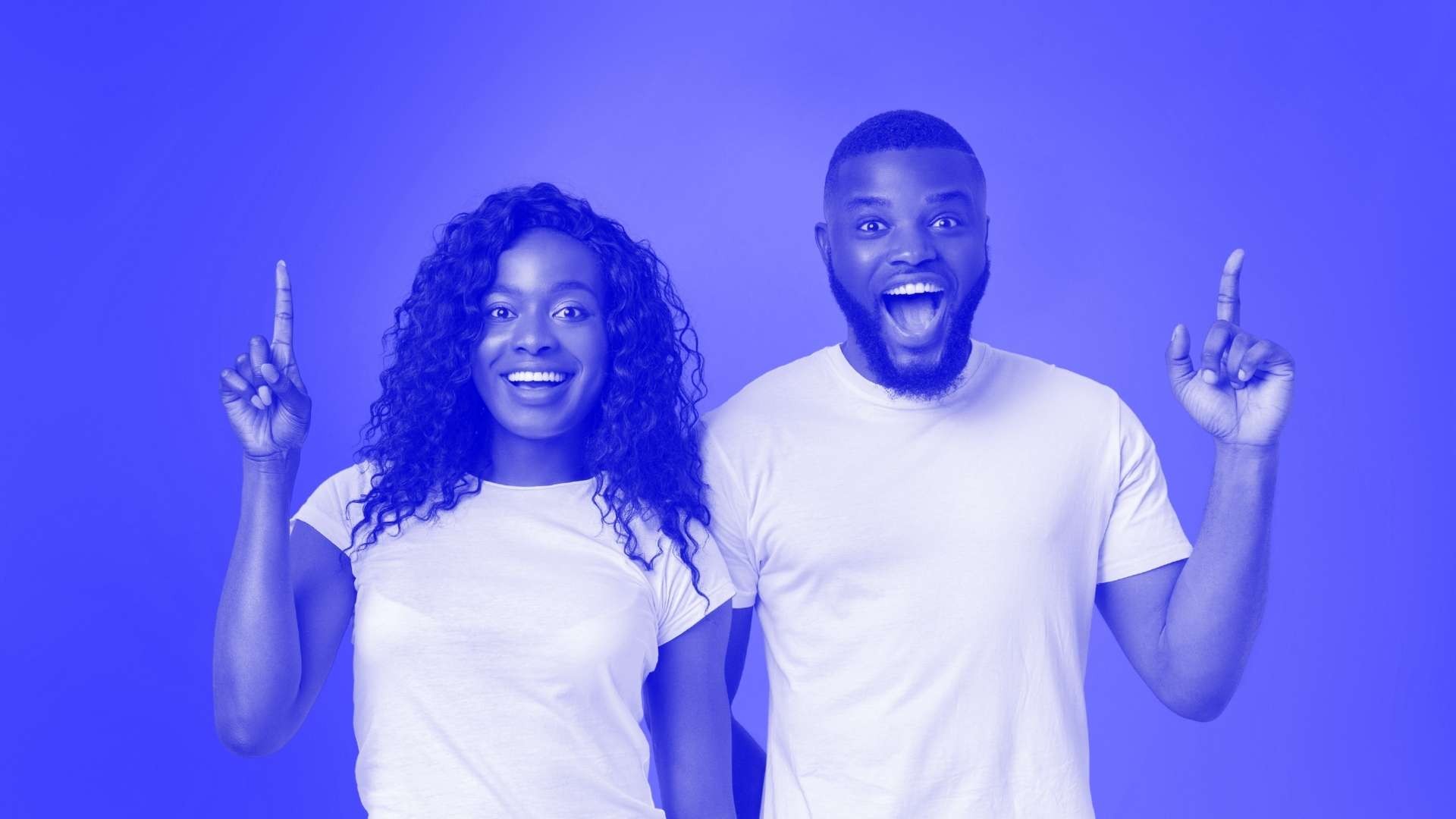 Two people standing next to each other with their finger in the air