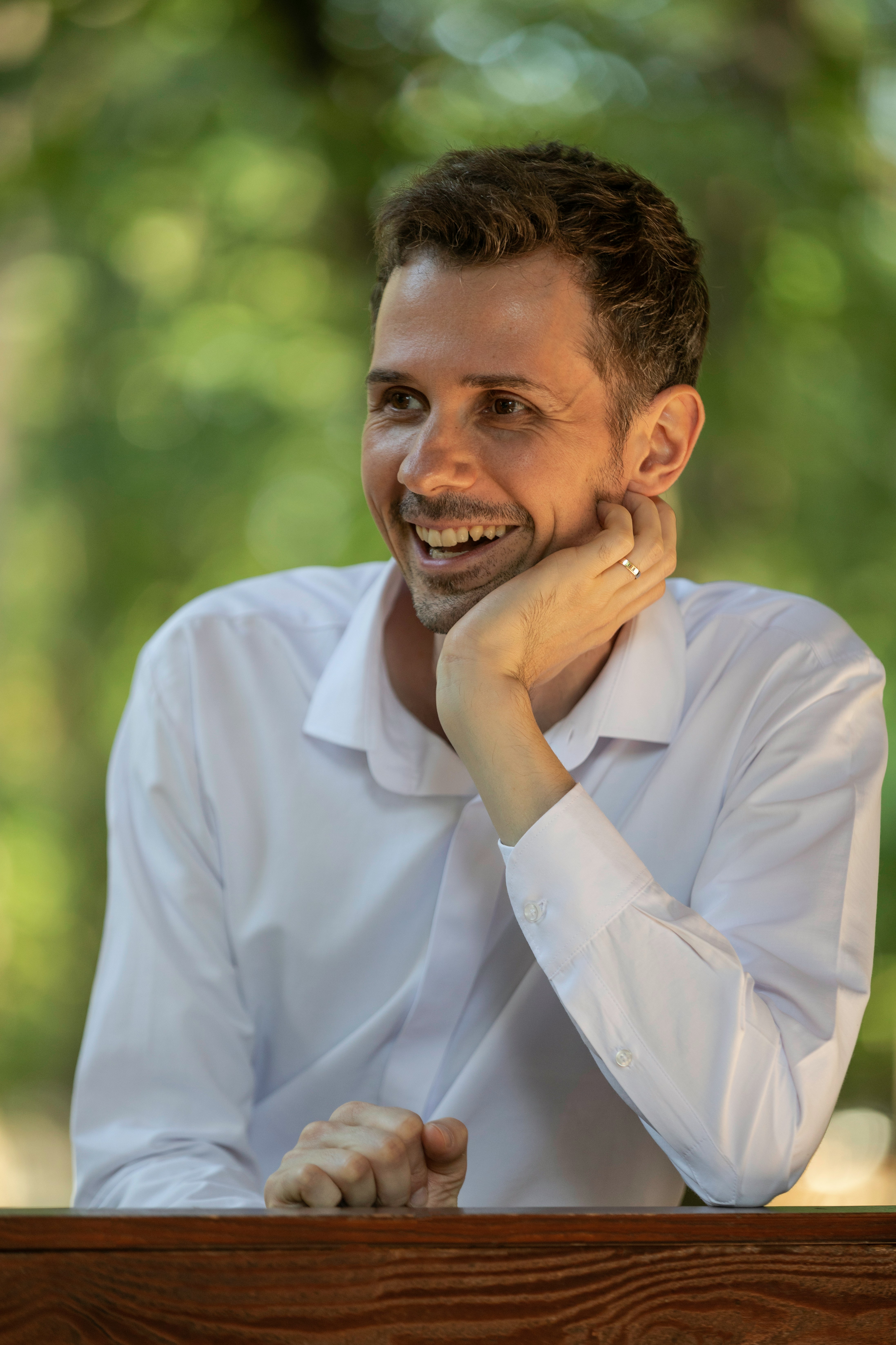 A man in a white shirt sitting at a table