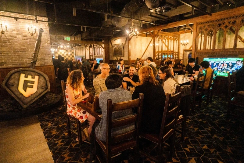 Group of people sitting at a cocktail table in the Tavern