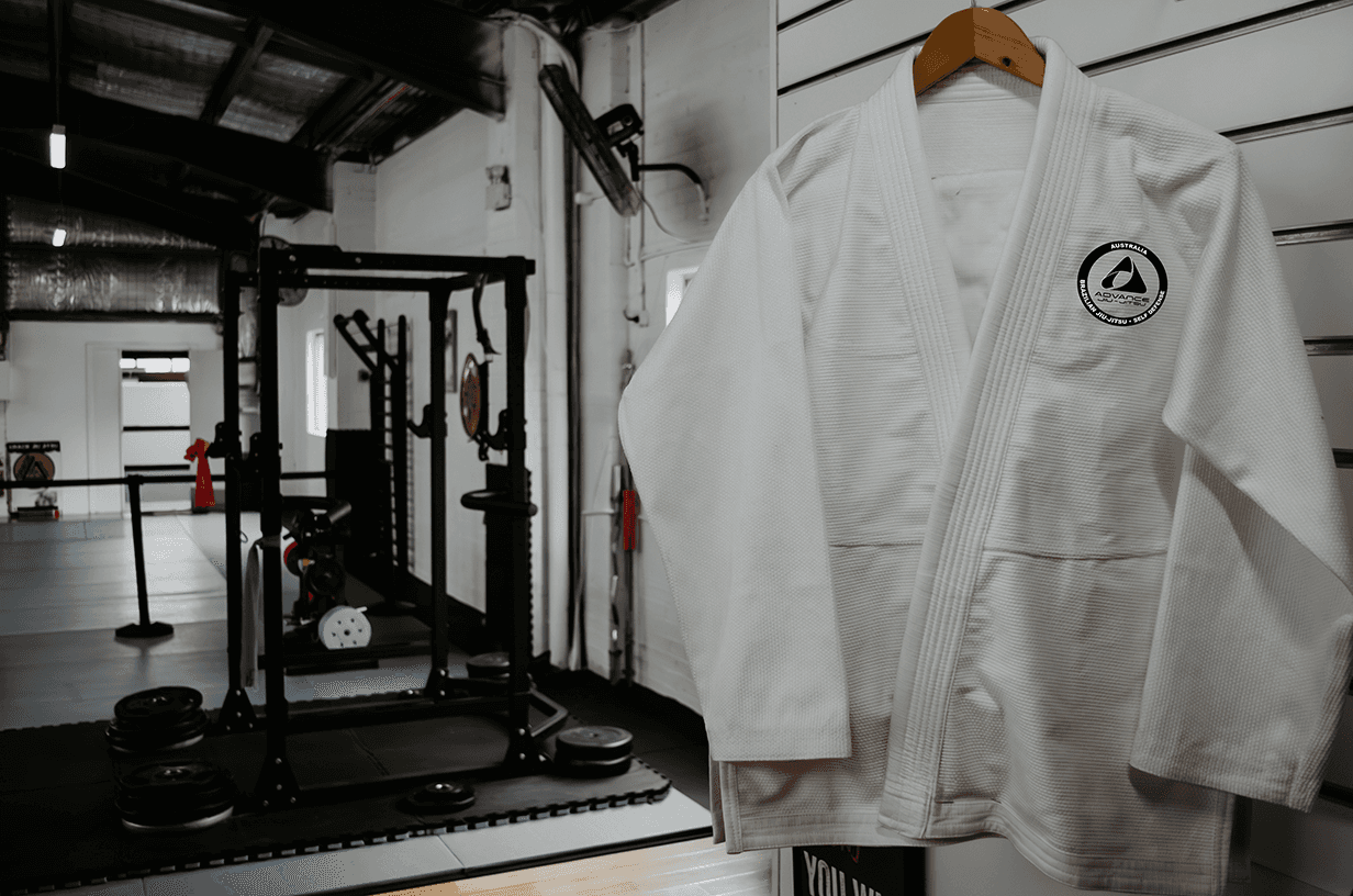 White gi uniforms hanging neatly in the locker area