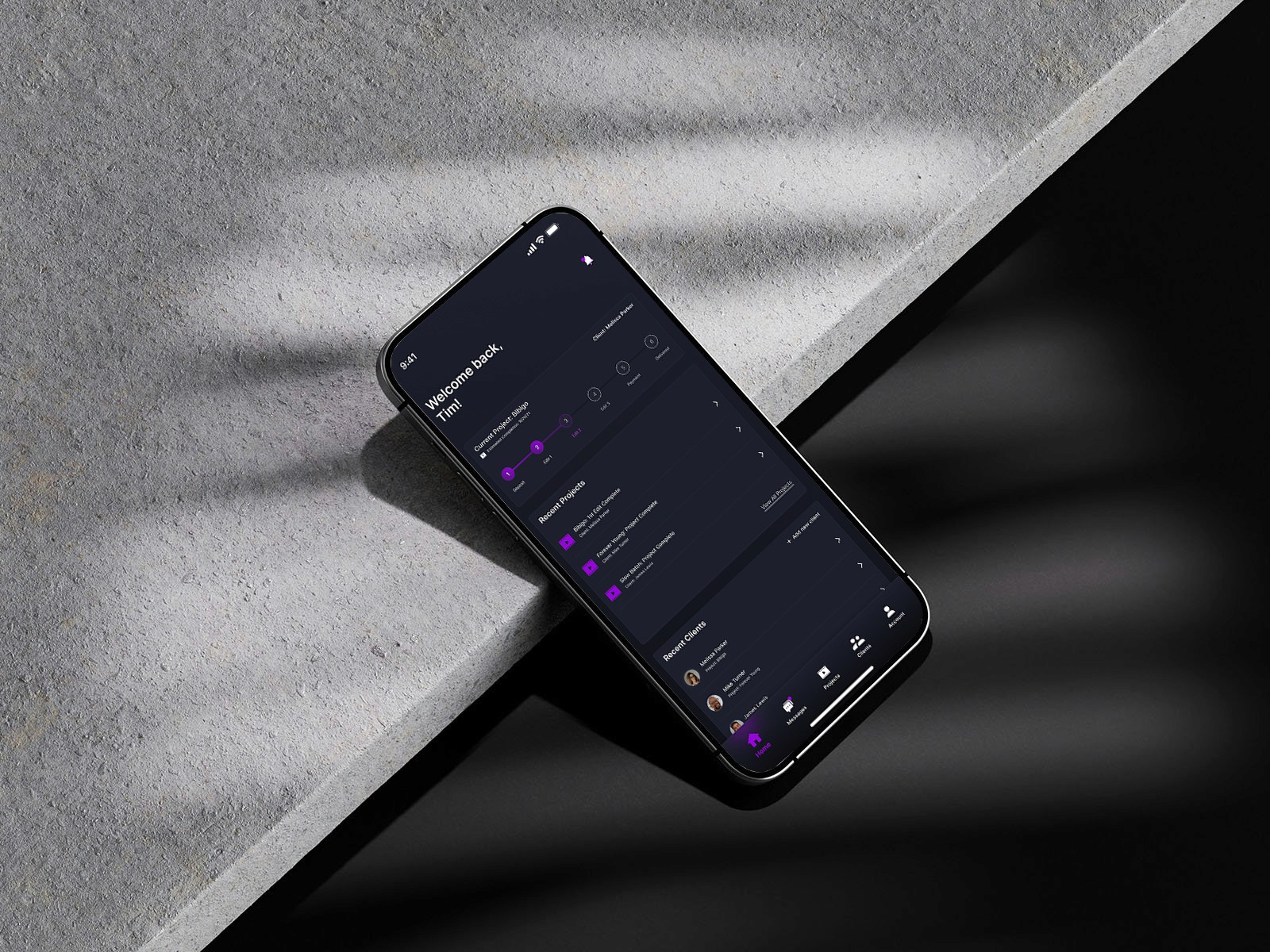 A smartphone leaning on a sleek piece of stone showcasing a media app design