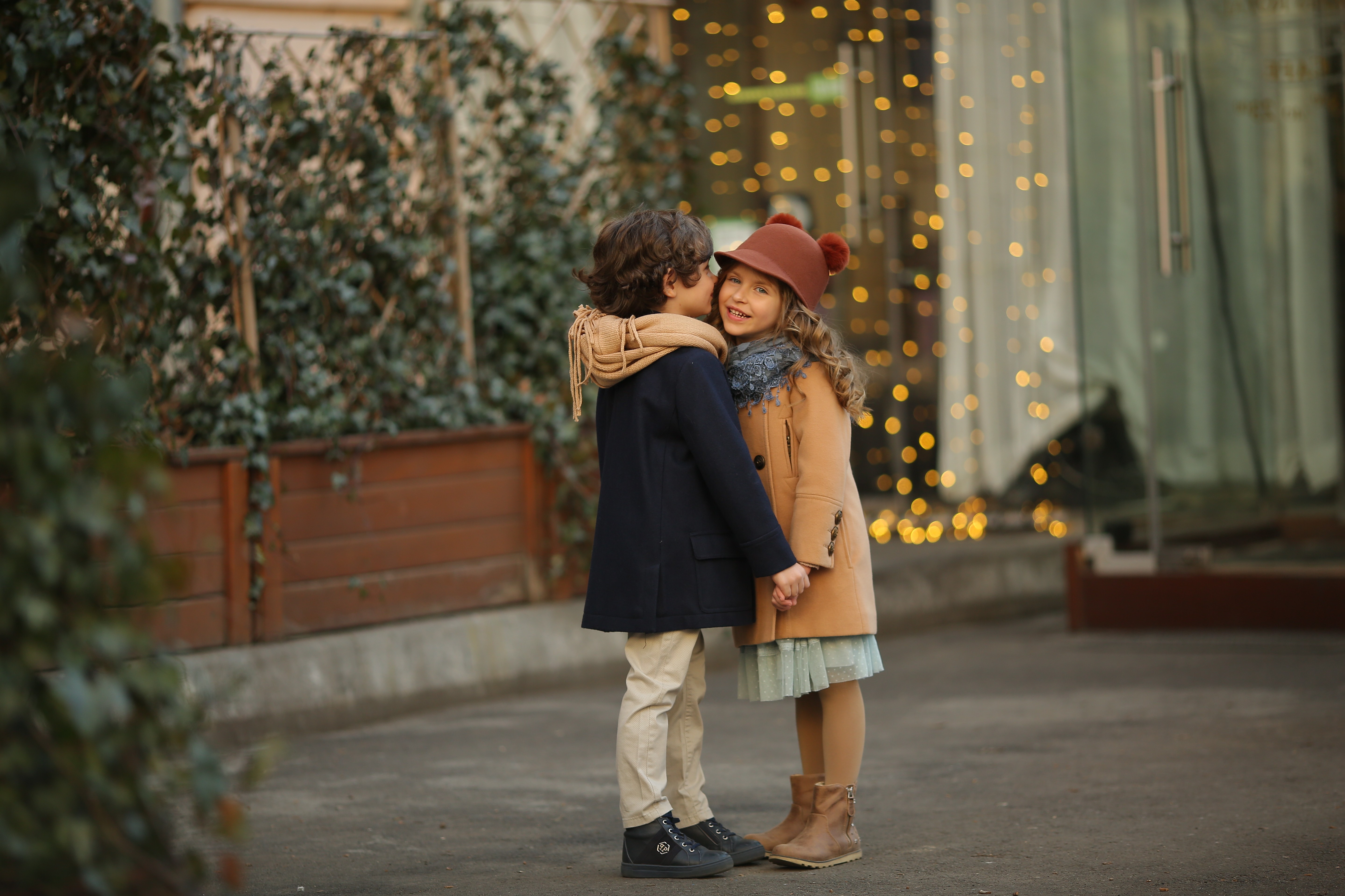 Siblings hugging during a cozy lifestyle family session with warm autumn tones.