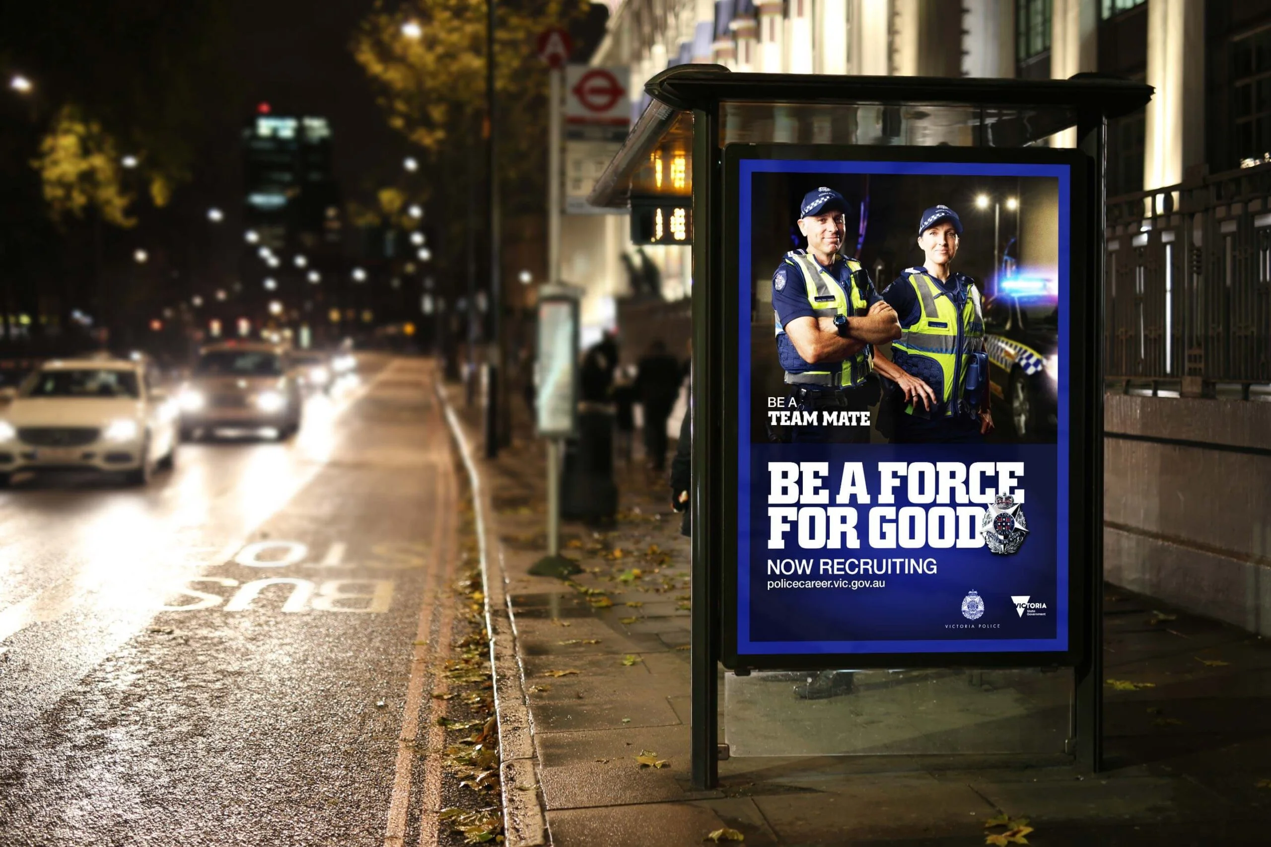 Night bus shelter poster: Victoria Police 'Be a force for good. Now recruiting', two officers in hi-vis, 'Be a team mate'