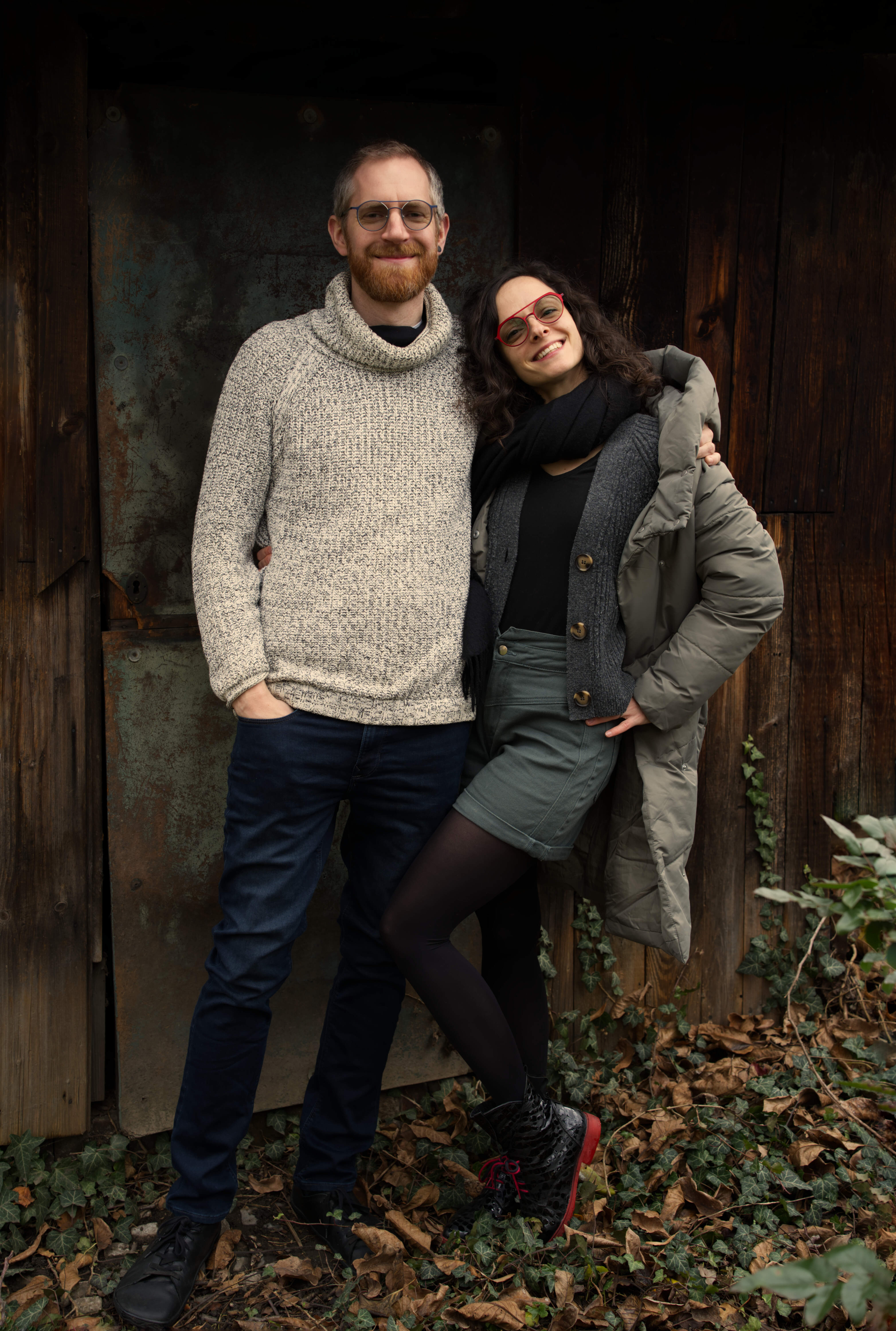 A mysteriously smiling woman covers her face with a newspaper