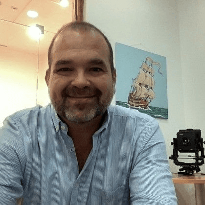 man standing beside wall