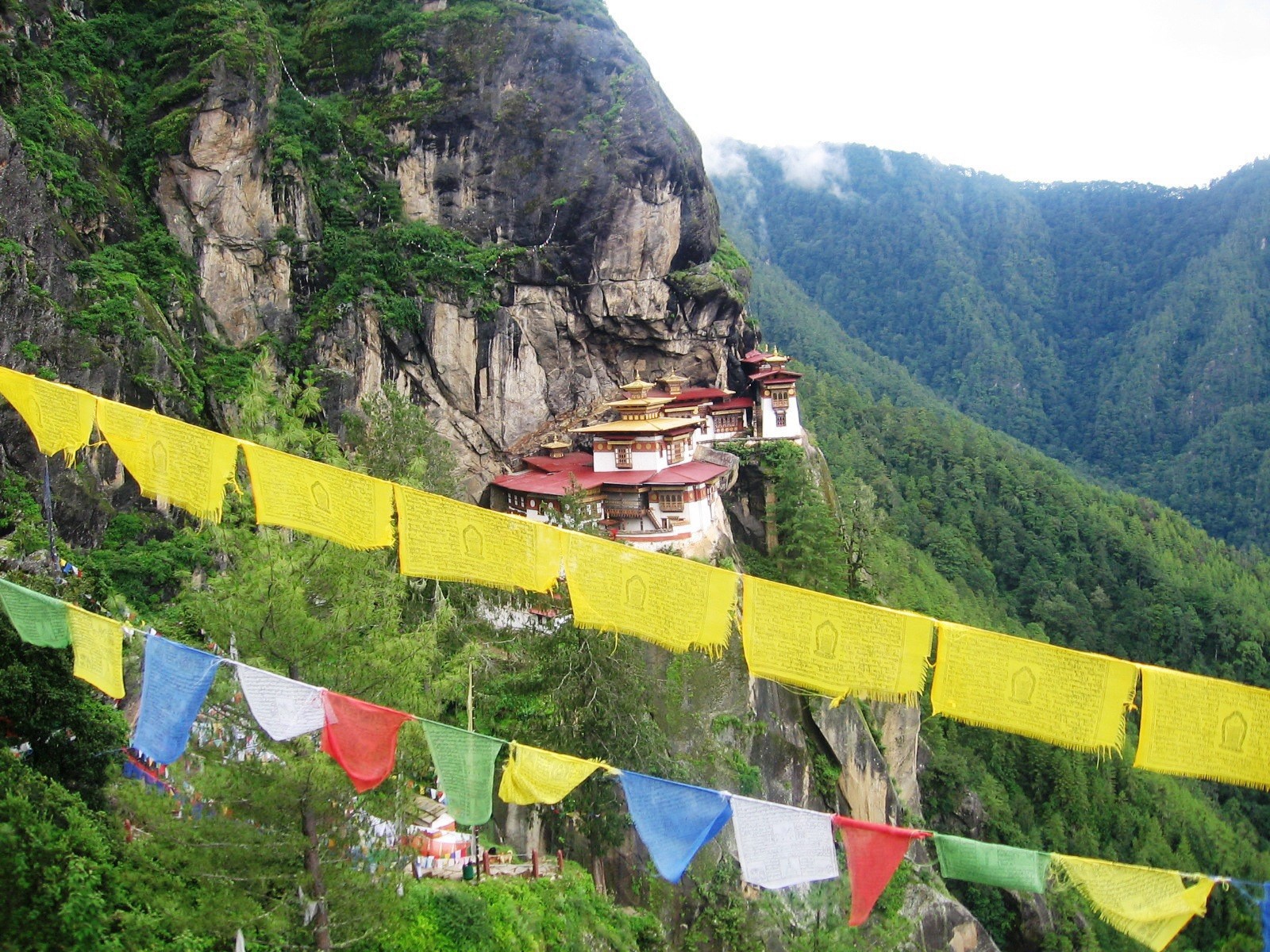 Taktsang Monastery across the gorge, prayer flags in the foreground